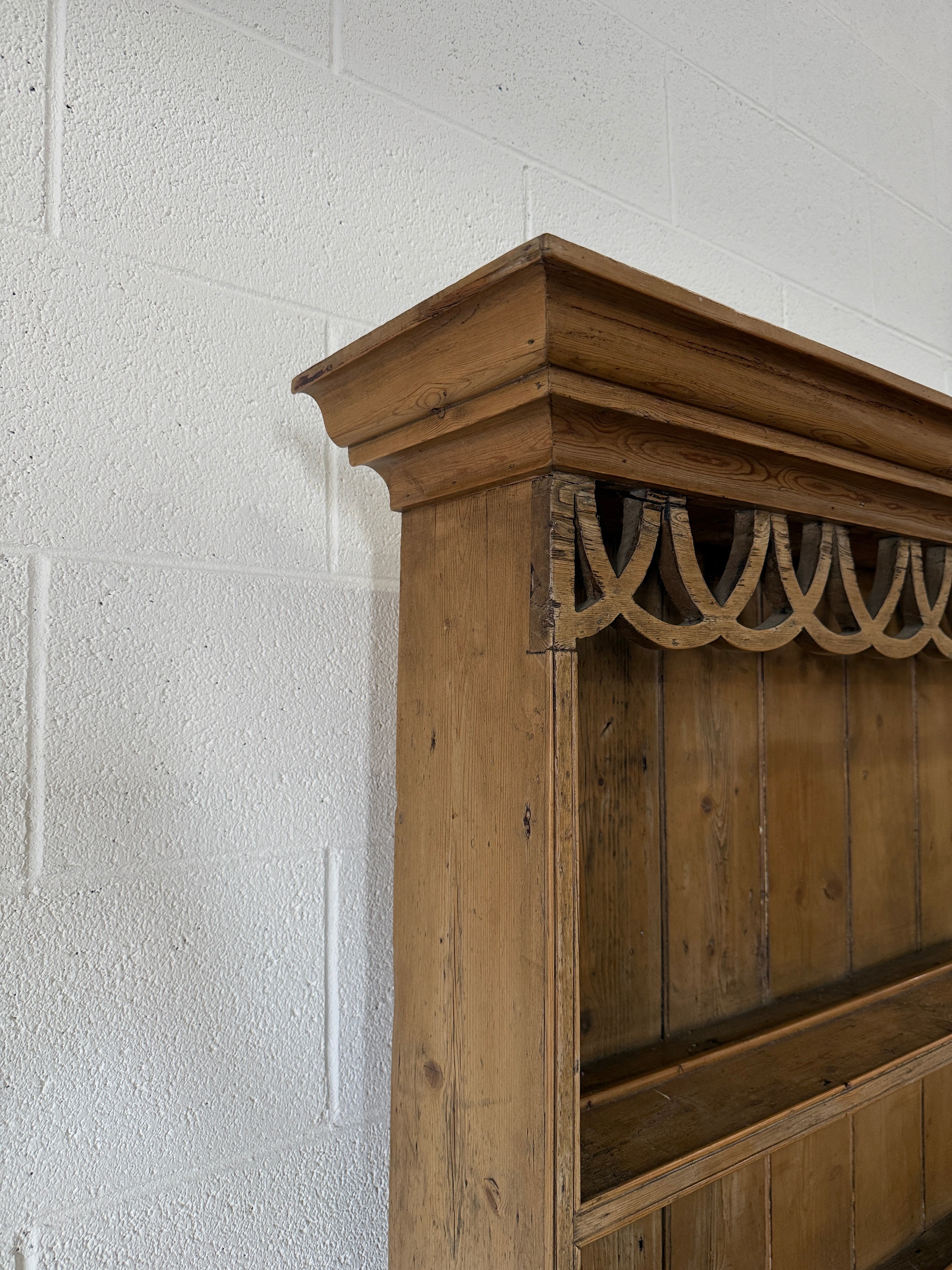 Antique pine kitchen dresser with decorative top
