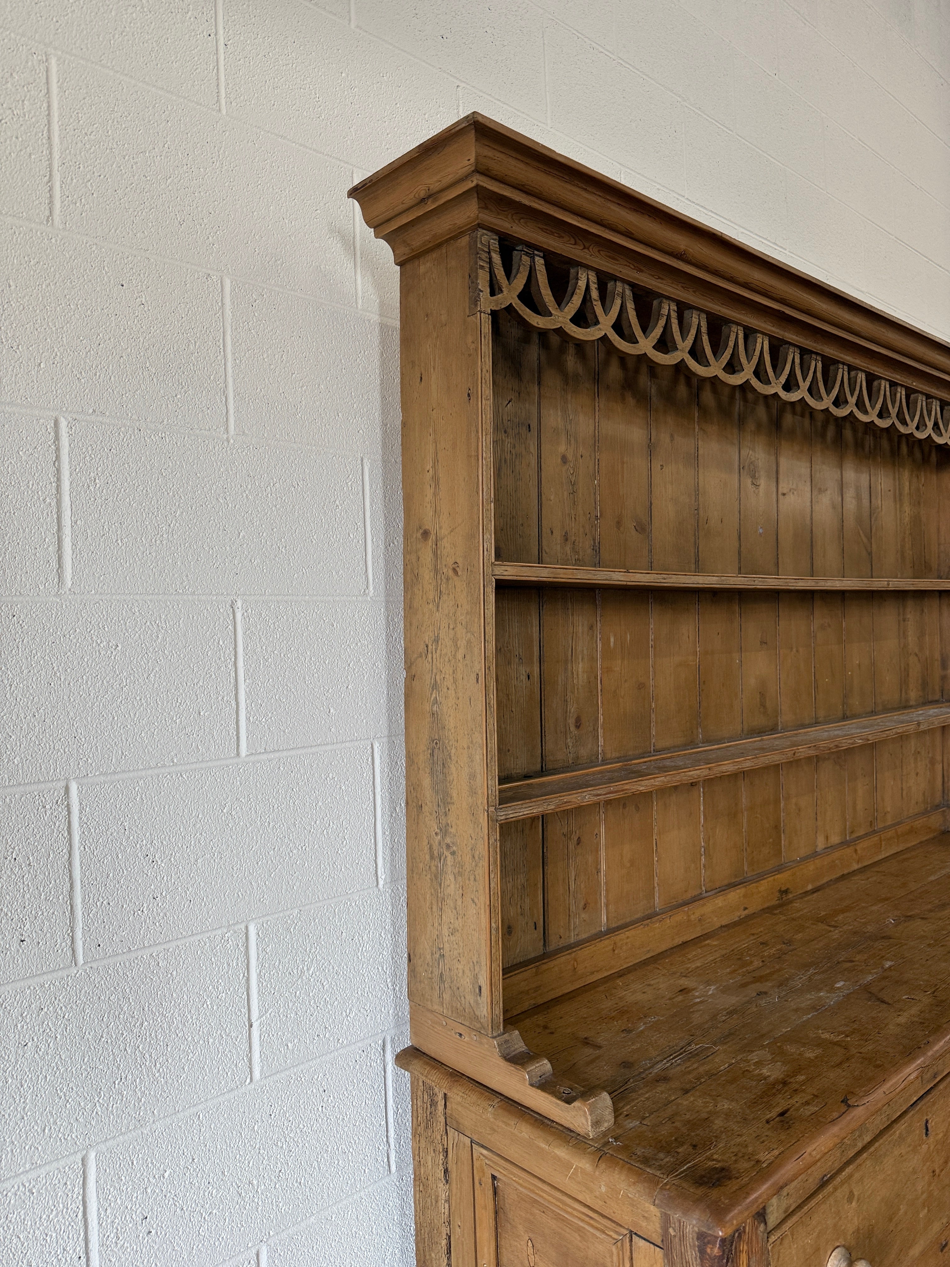 Antique pine kitchen dresser with decorative top