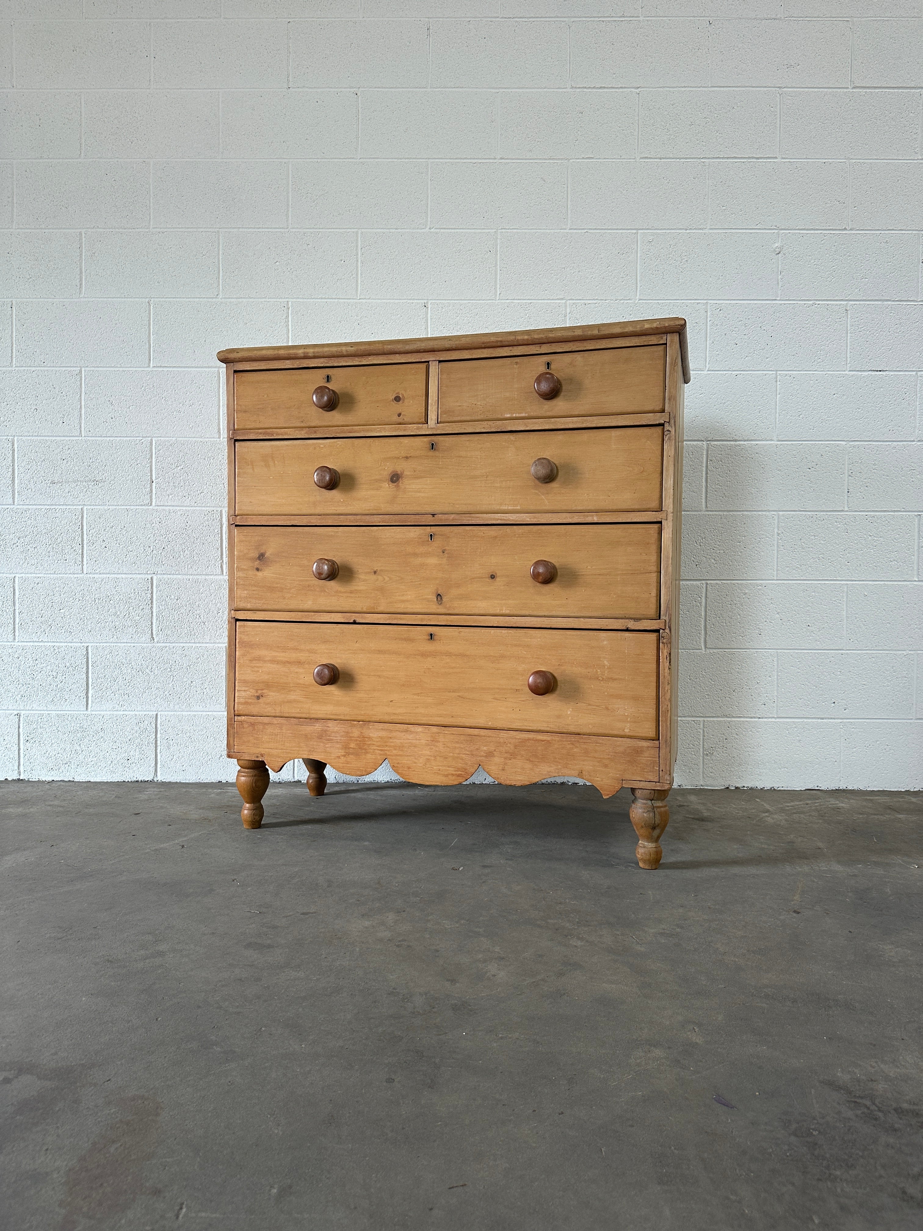 Tall English pine drawers with a scalloped apron