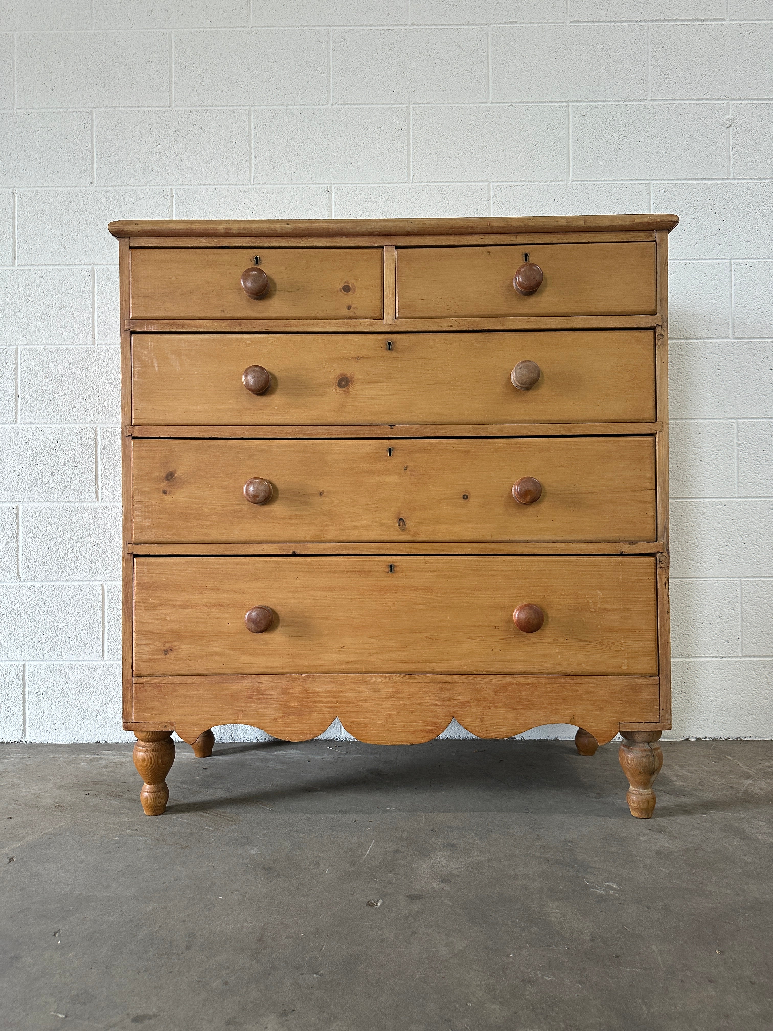 Tall English pine drawers with a scalloped apron