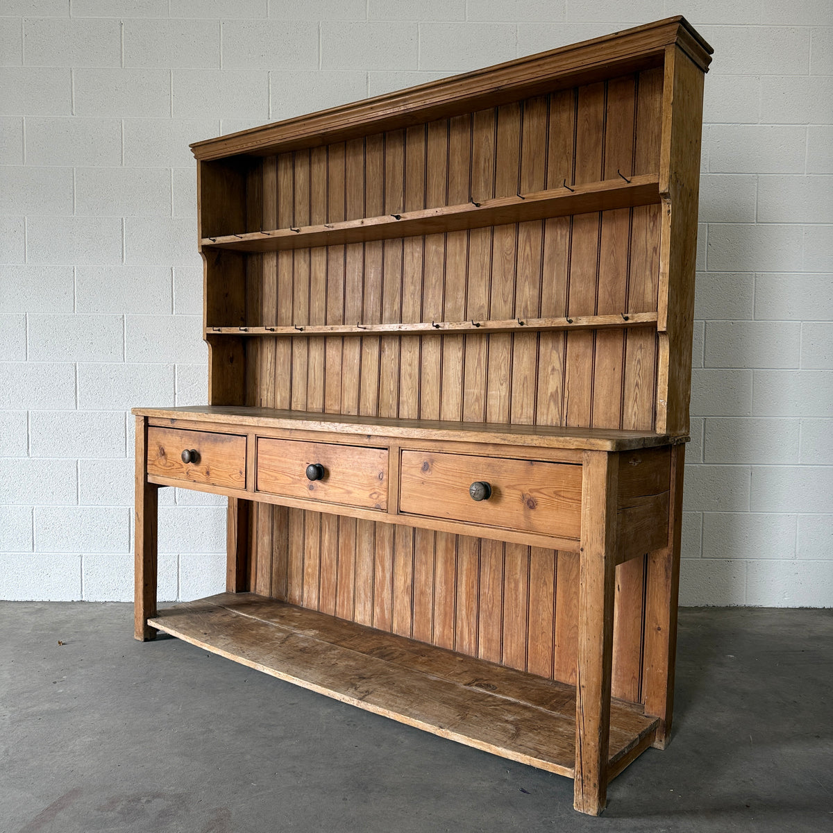 Simple antique English pine kitchen dresser with potboard base