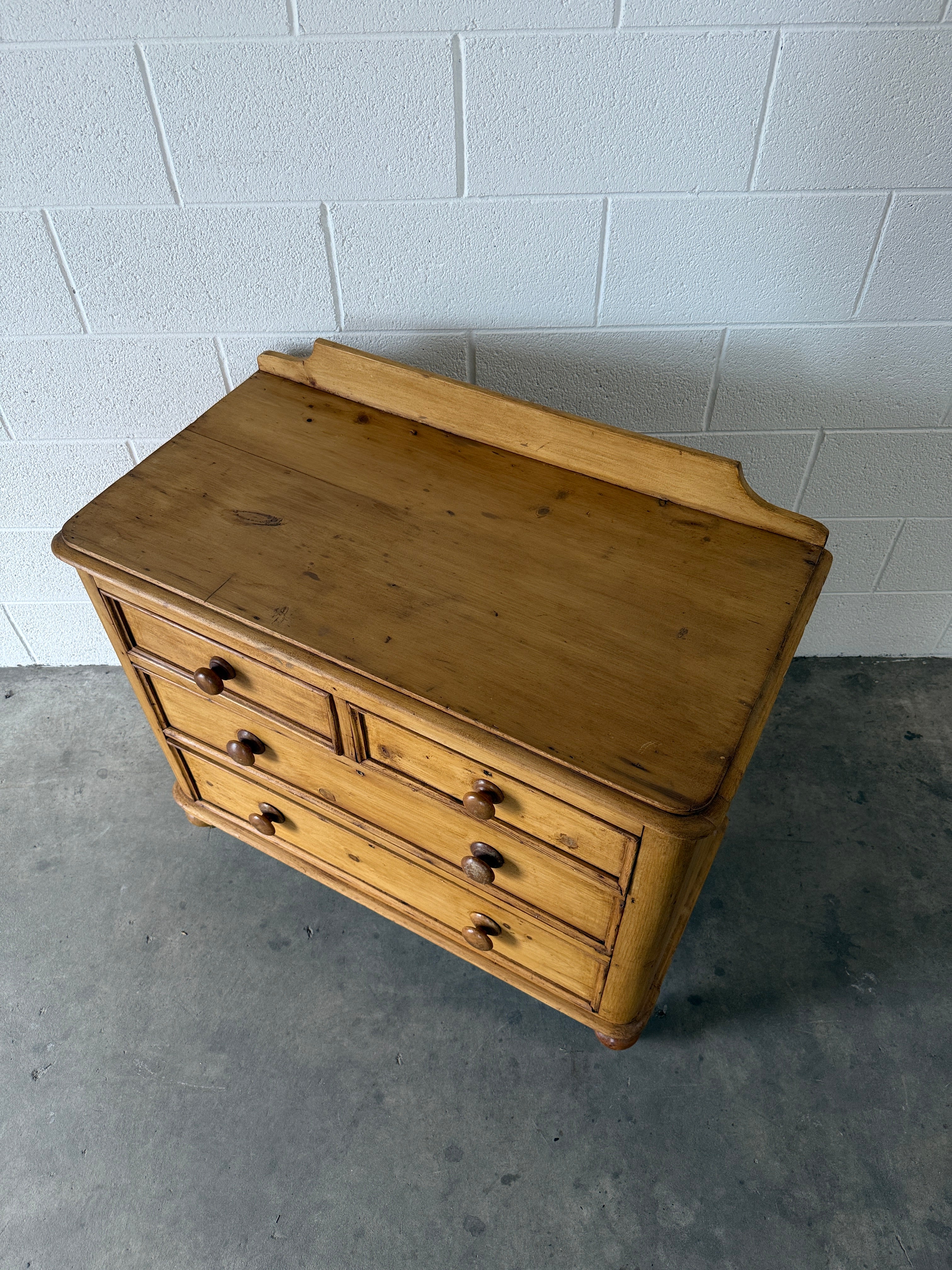 Small antique pine chest of drawers with gallery back