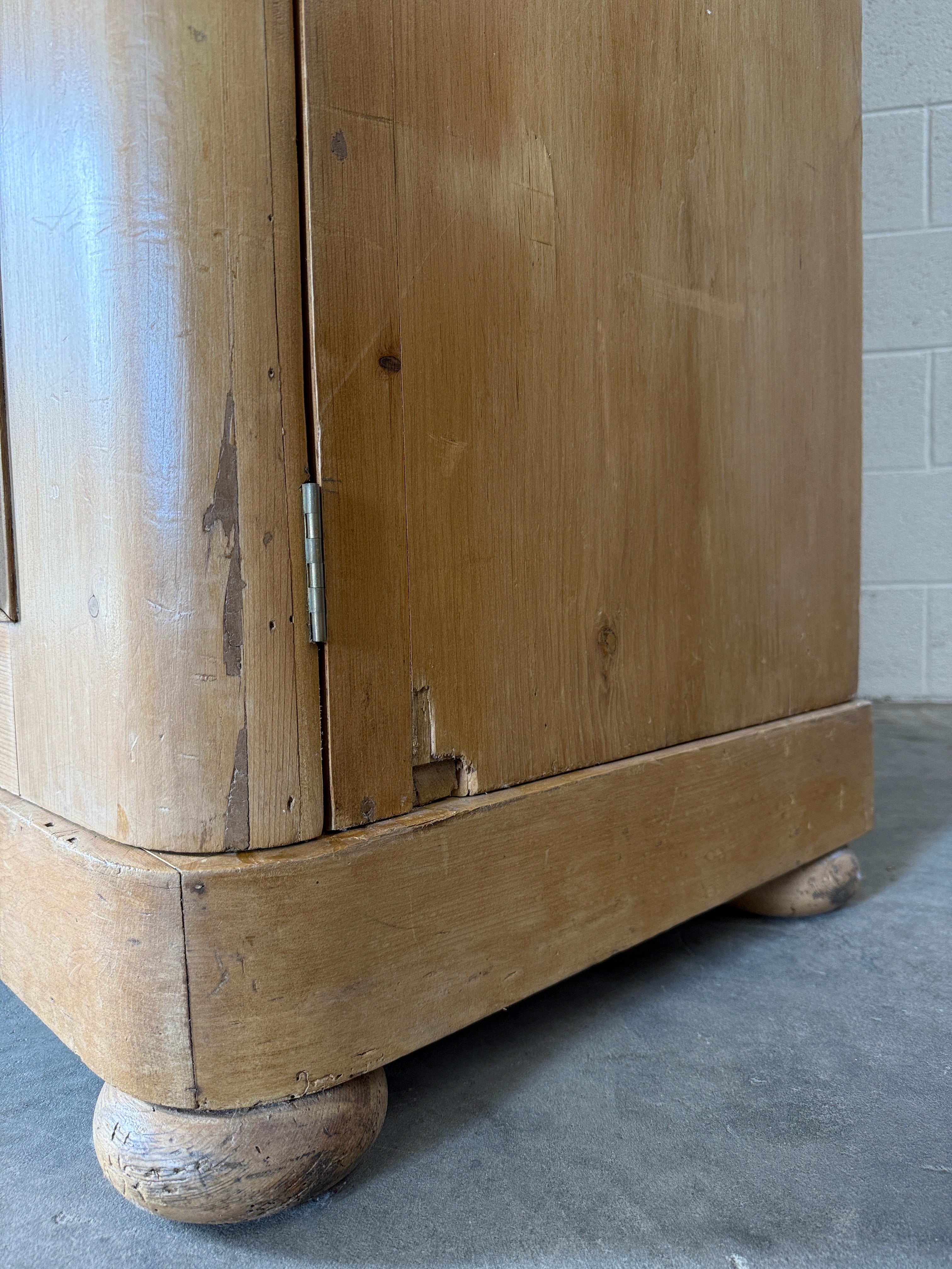 Antique English pine wardrobe with arched panel doors and fitted interior