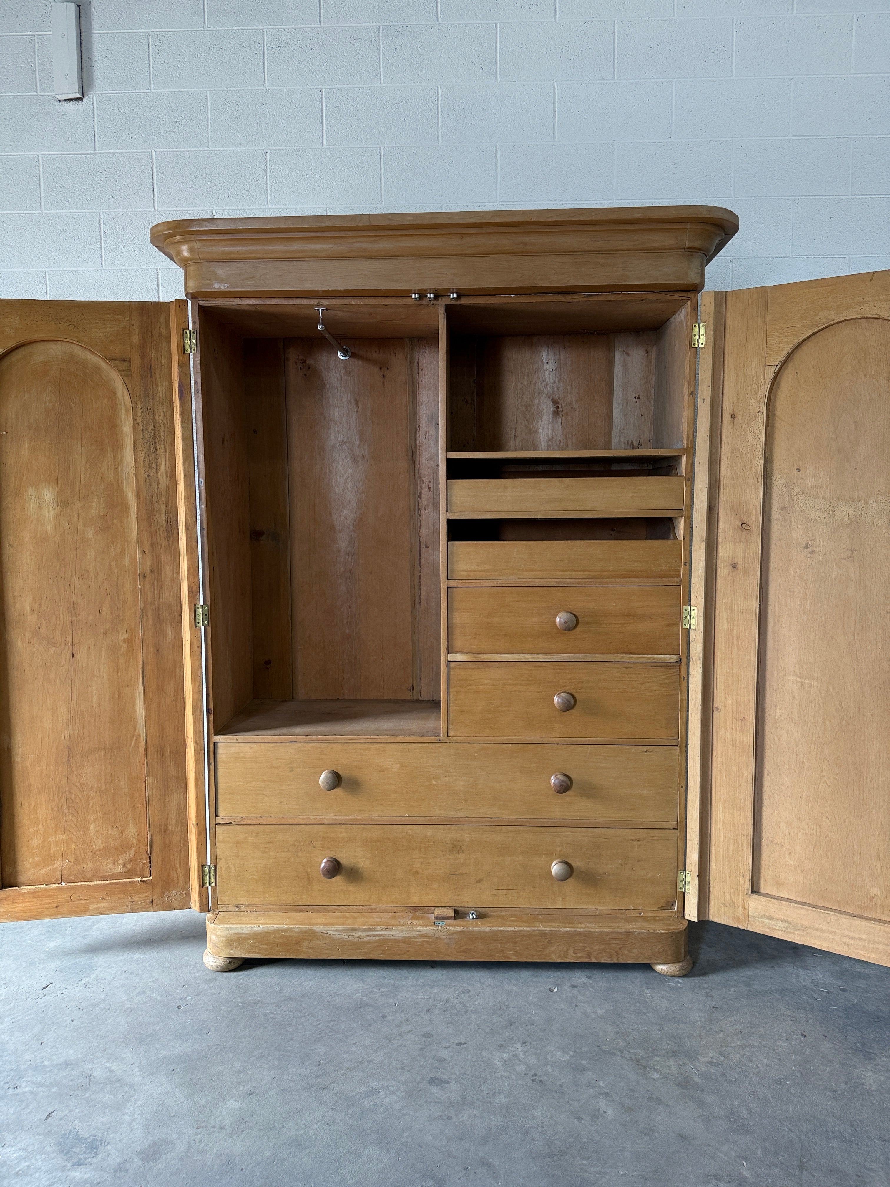 Antique English pine wardrobe with arched panel doors and fitted interior