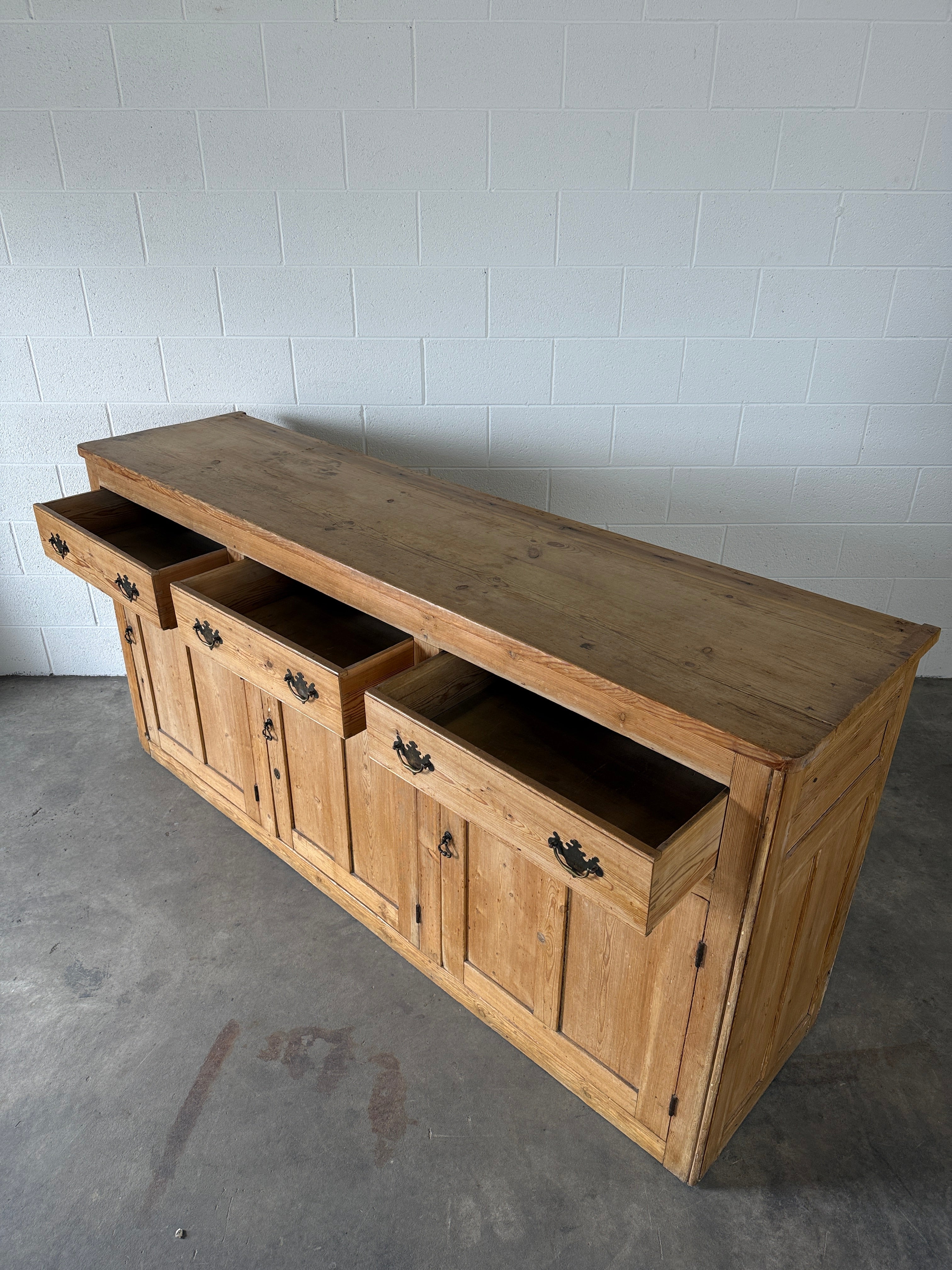 19th‑century English pine sideboard with three drawers and cupboards below