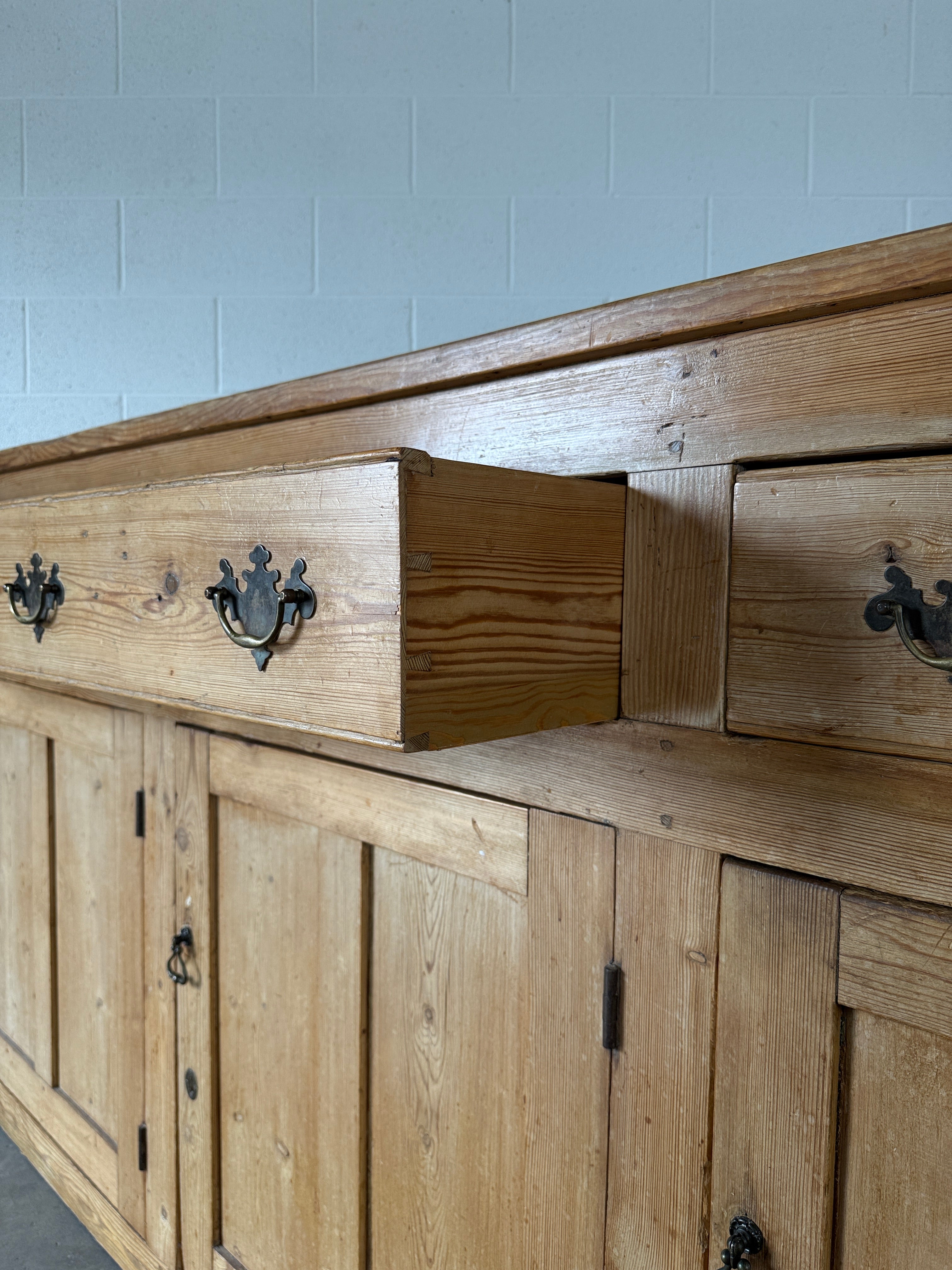 19th‑century English pine sideboard with three drawers and cupboards below
