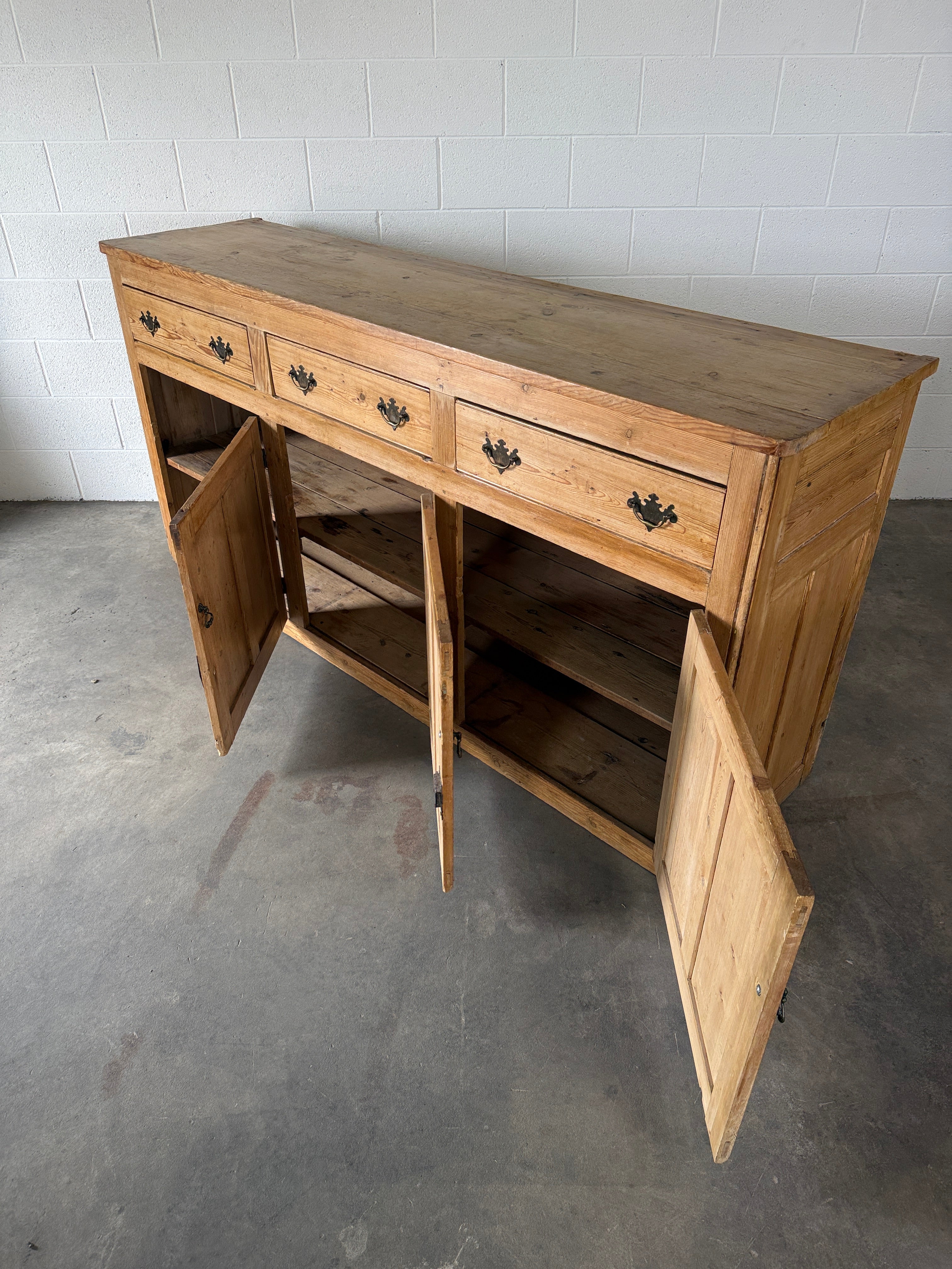 19th‑century English pine sideboard with three drawers and cupboards below