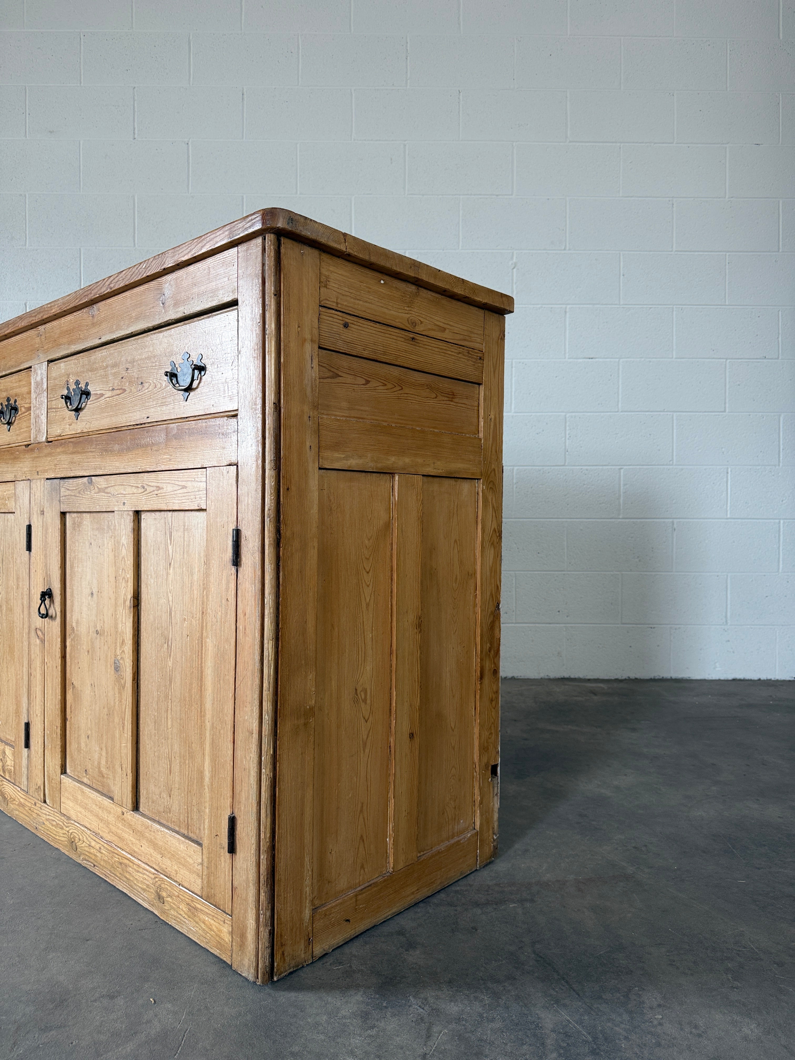 19th‑century English pine sideboard with three drawers and cupboards below