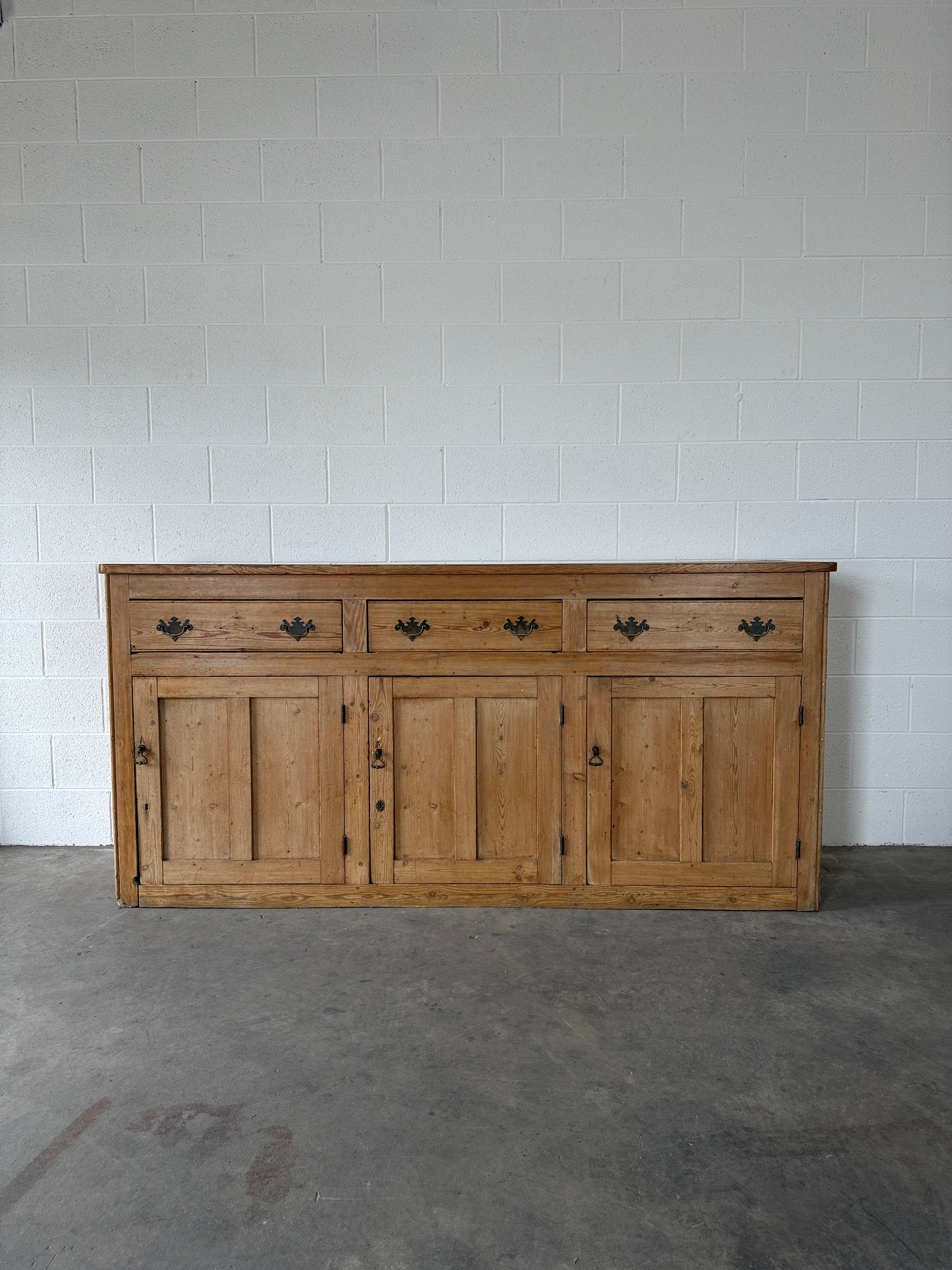 19th‑century English pine sideboard with three drawers and cupboards below