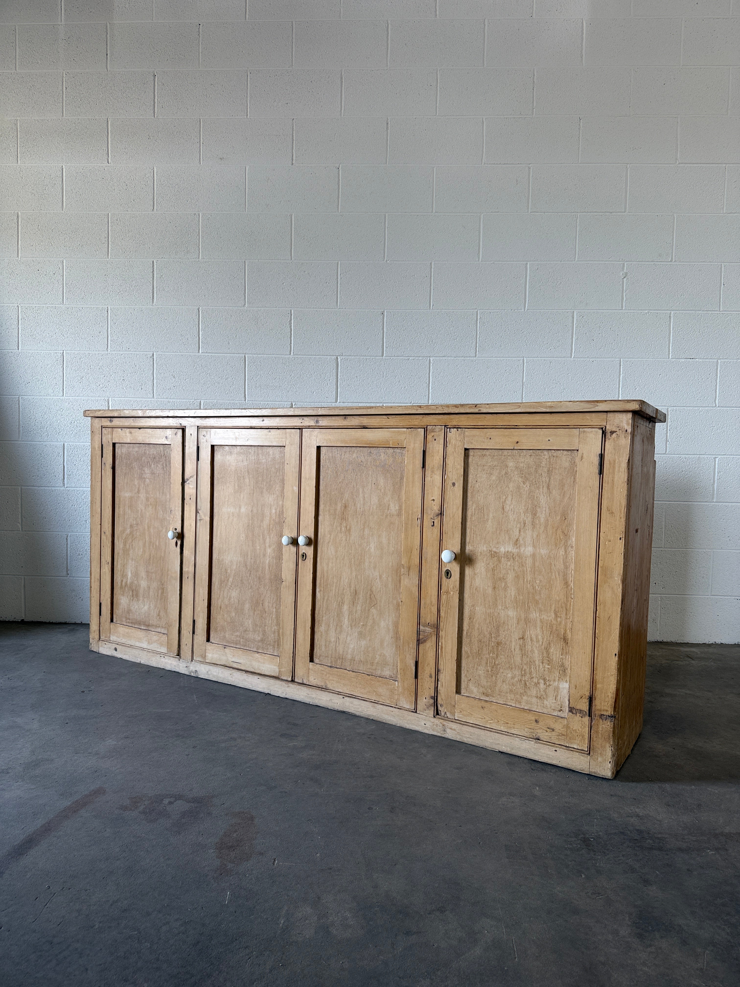 Simple antique pine sideboard with four doors
