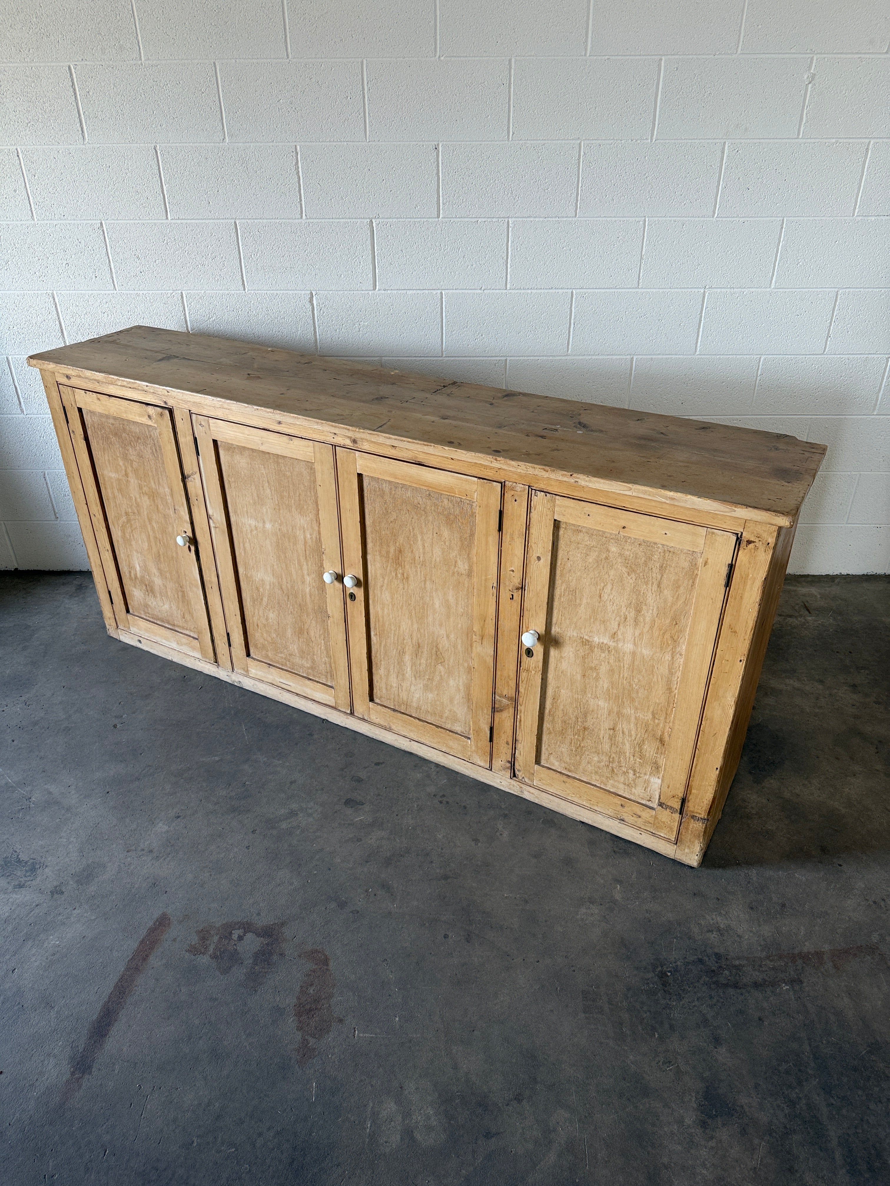 Simple antique pine sideboard with four doors