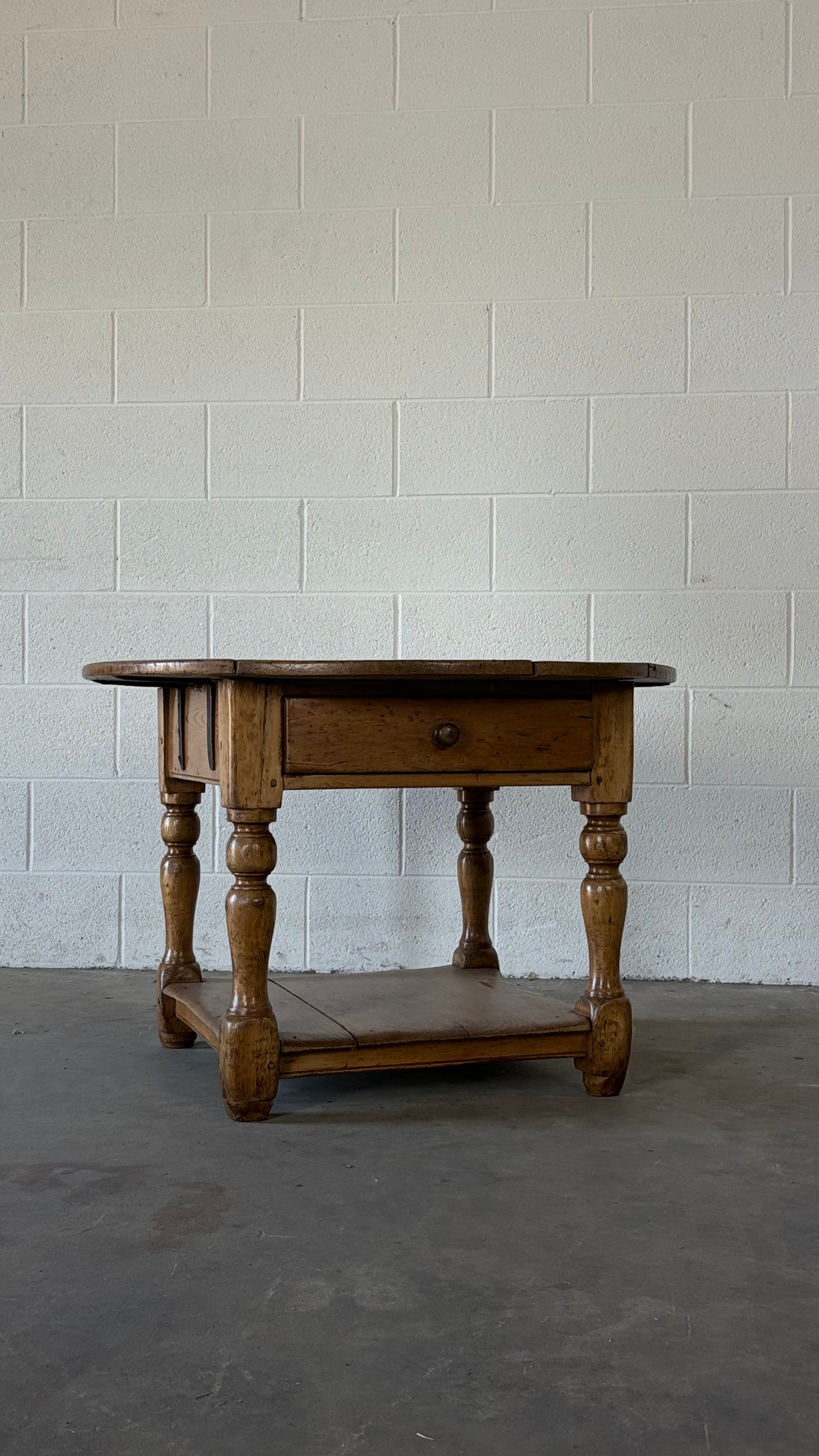 Small round pine coffee table with lower shelf