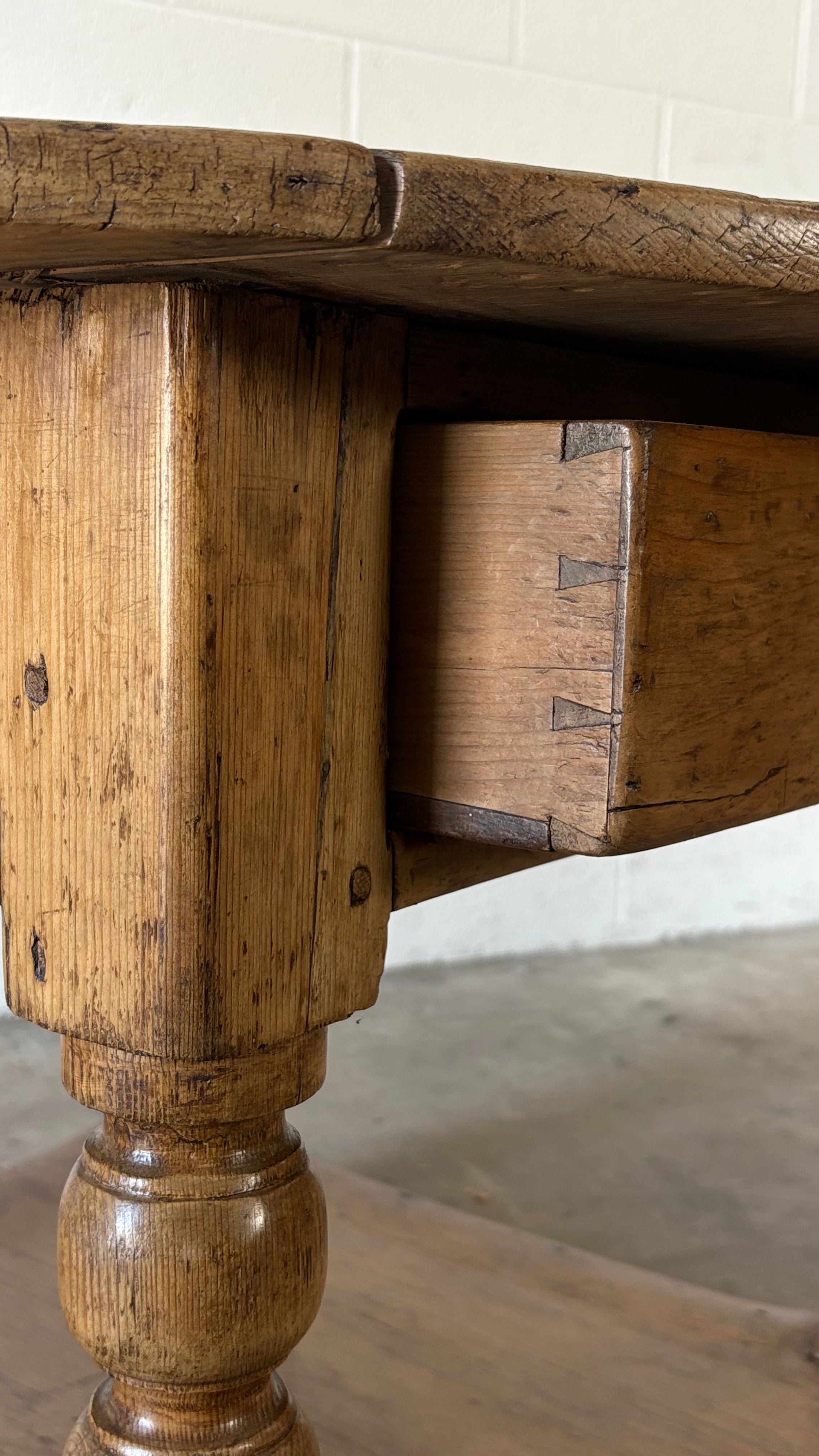 Small round pine coffee table with lower shelf