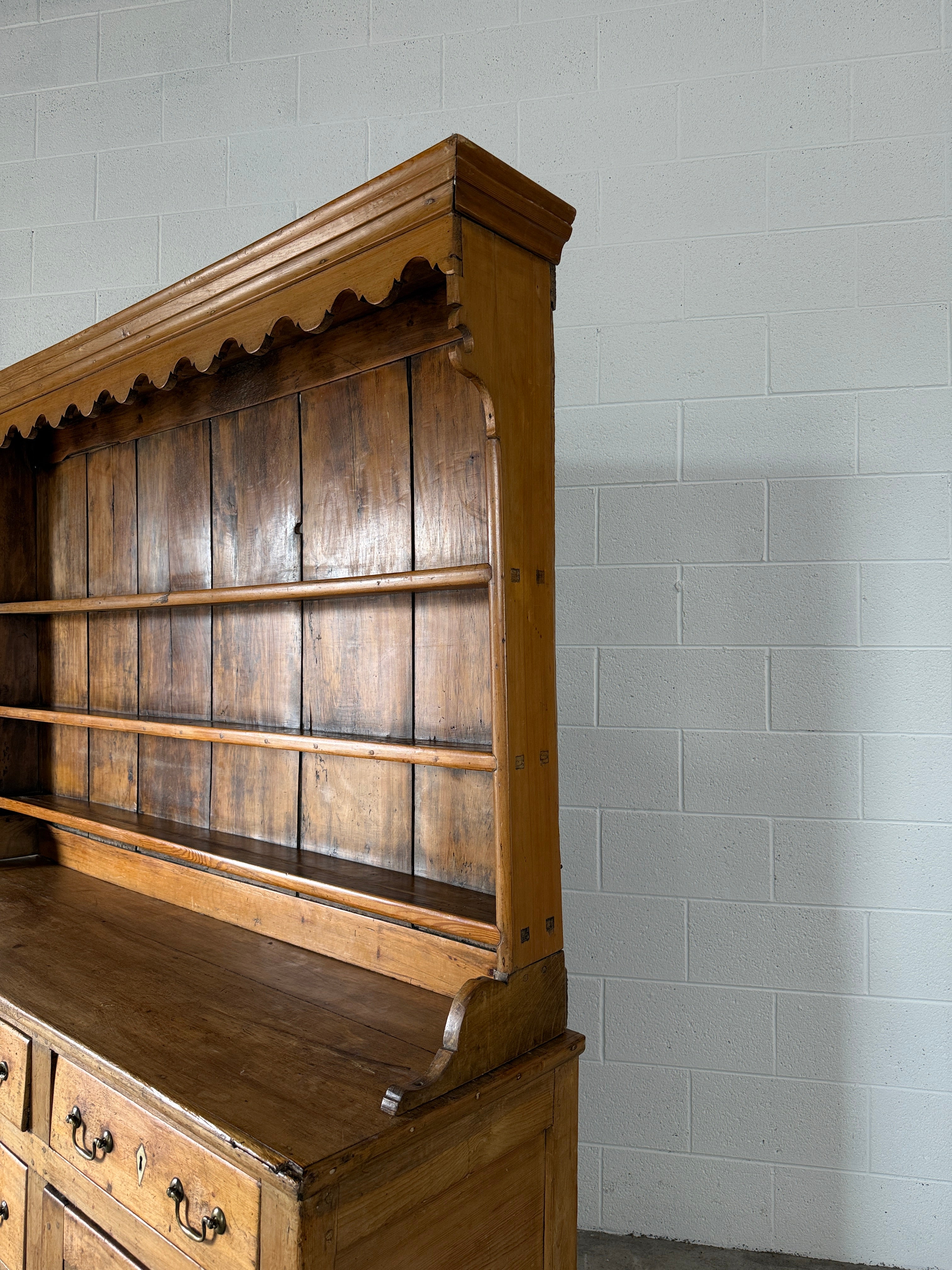 Antique English pine kitchen dresser with paneled doors and detailed trim work