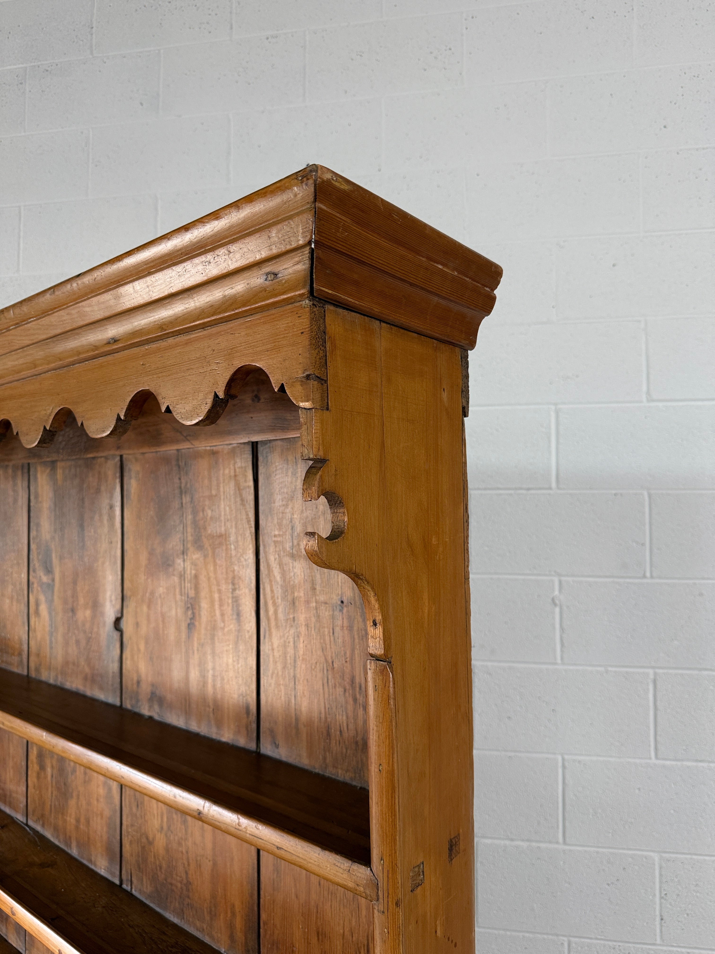 Antique English pine kitchen dresser with paneled doors and detailed trim work
