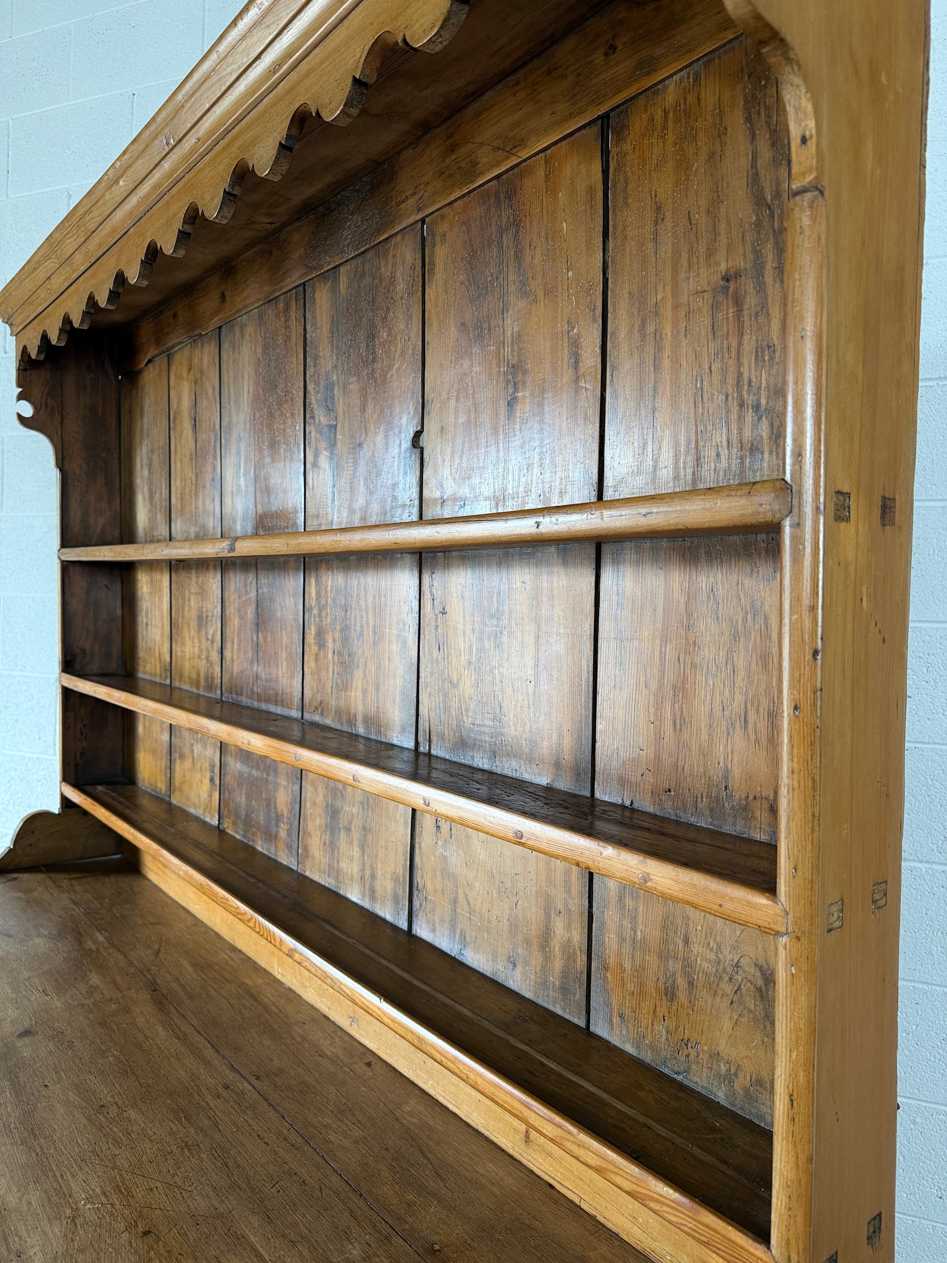 Antique English pine kitchen dresser with paneled doors and detailed trim work