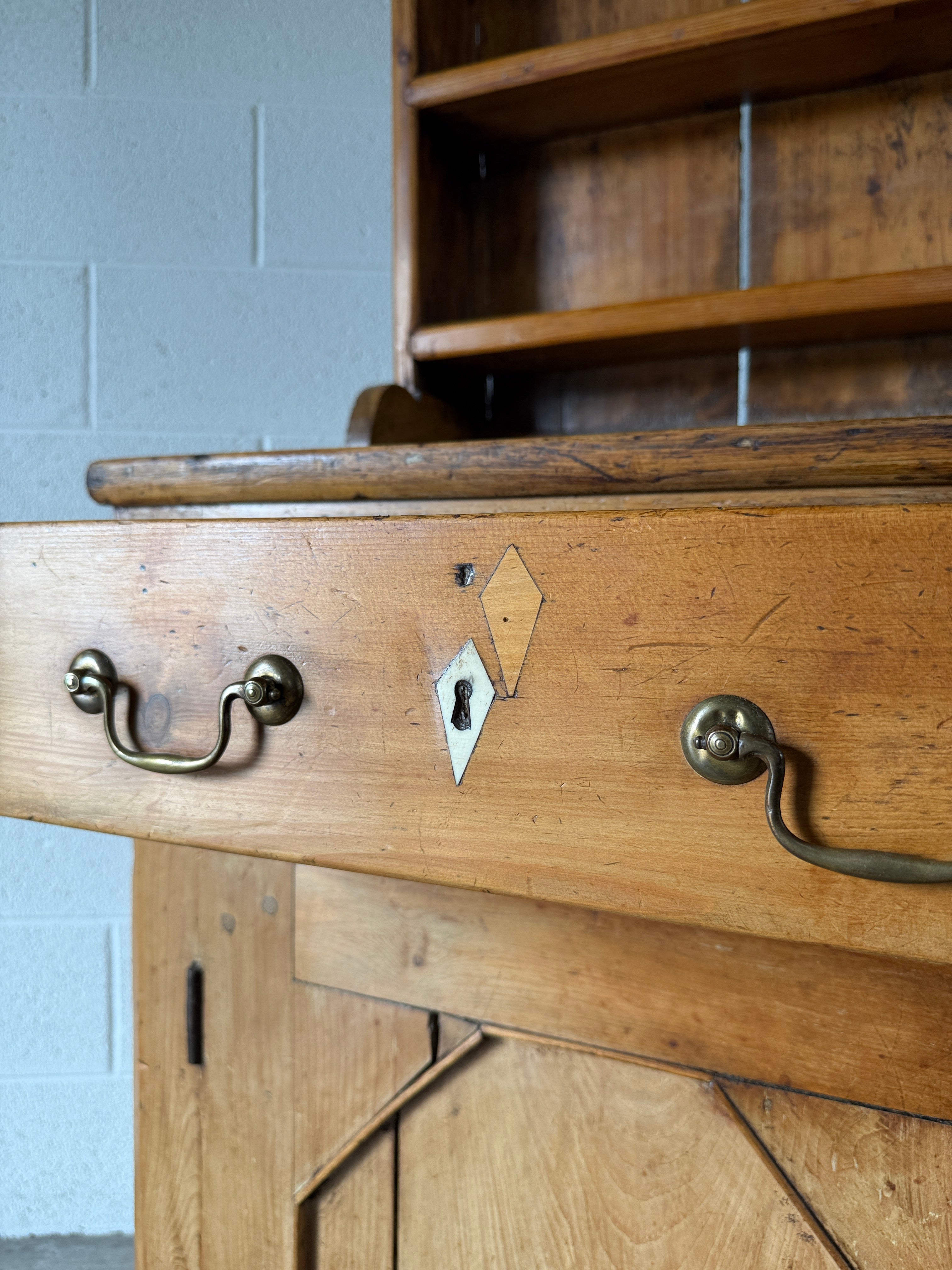 Antique English pine kitchen dresser with paneled doors and detailed trim work