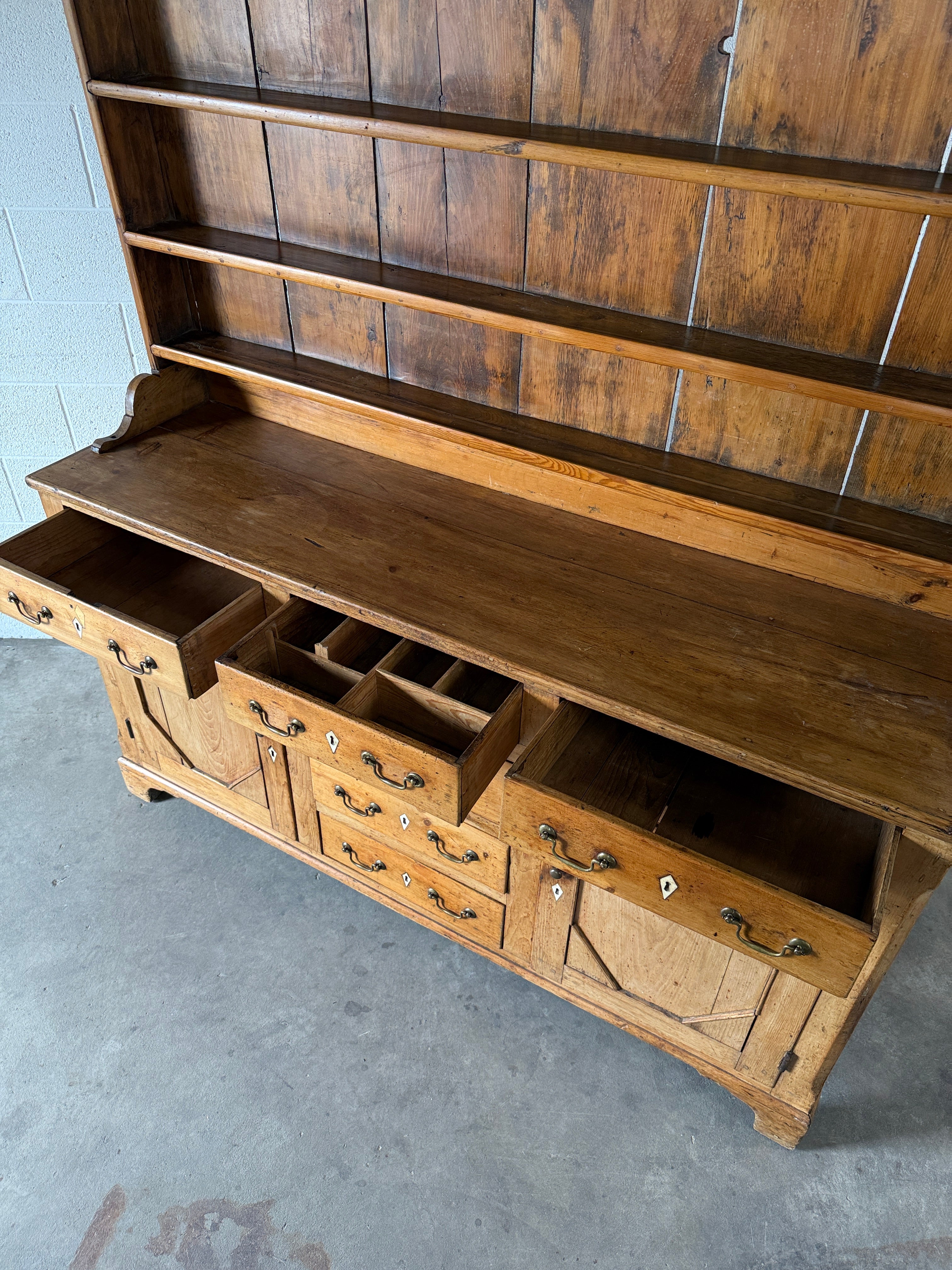 Antique English pine kitchen dresser with paneled doors and detailed trim work