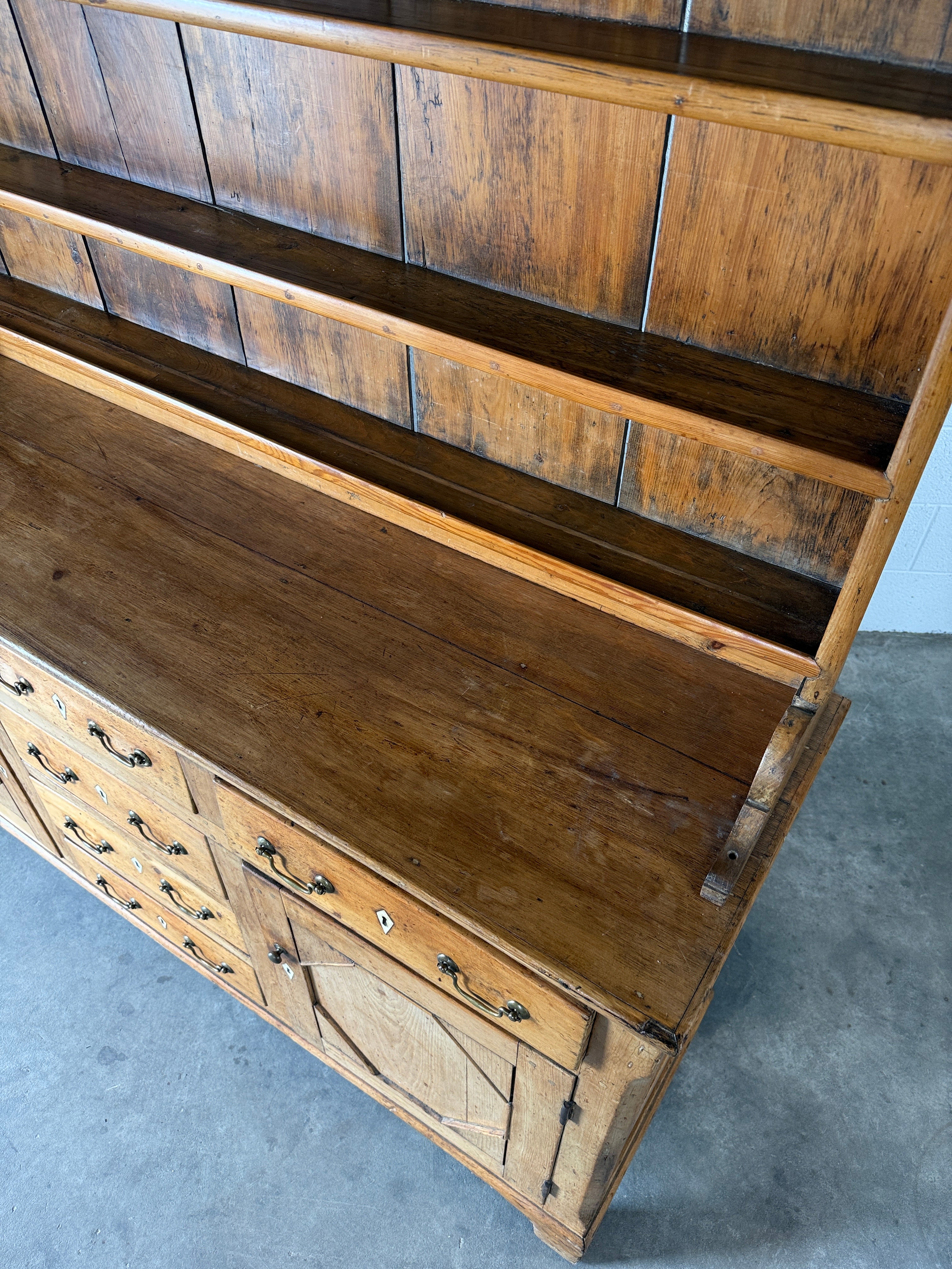 Antique English pine kitchen dresser with paneled doors and detailed trim work
