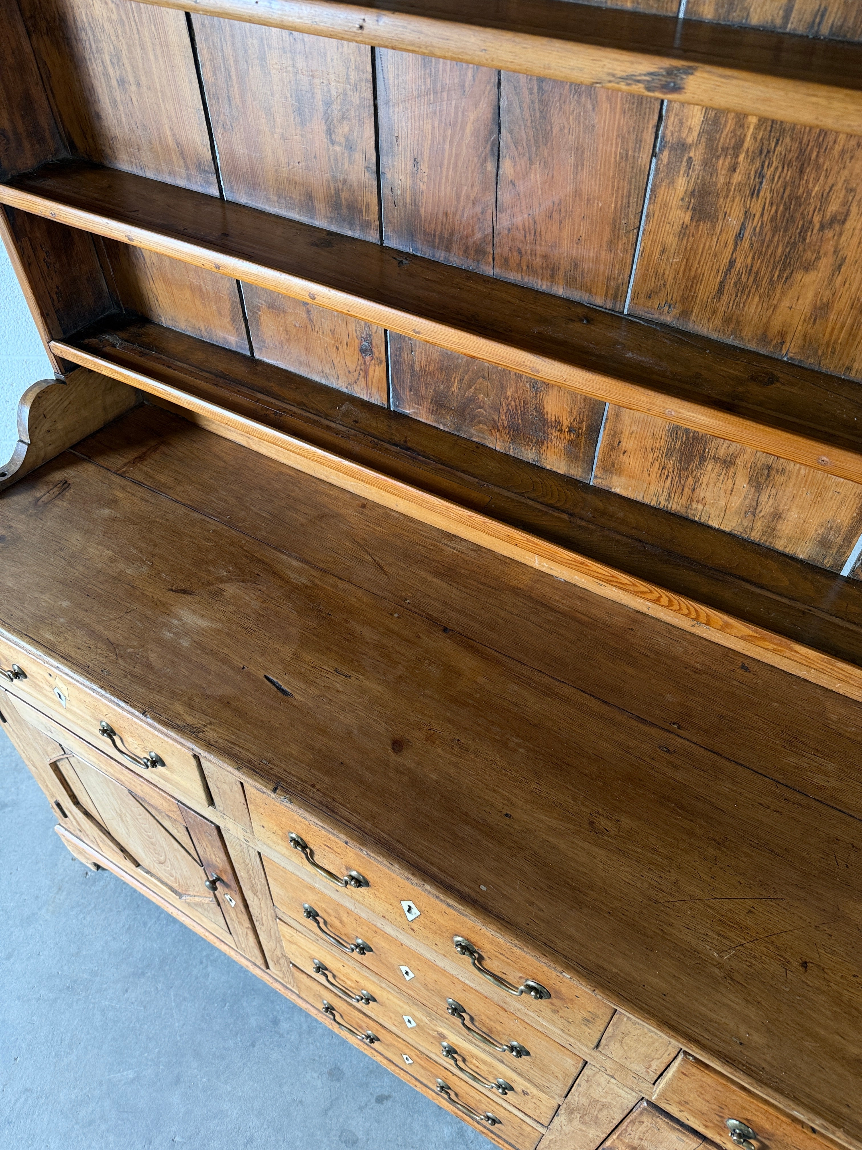 Antique English pine kitchen dresser with paneled doors and detailed trim work