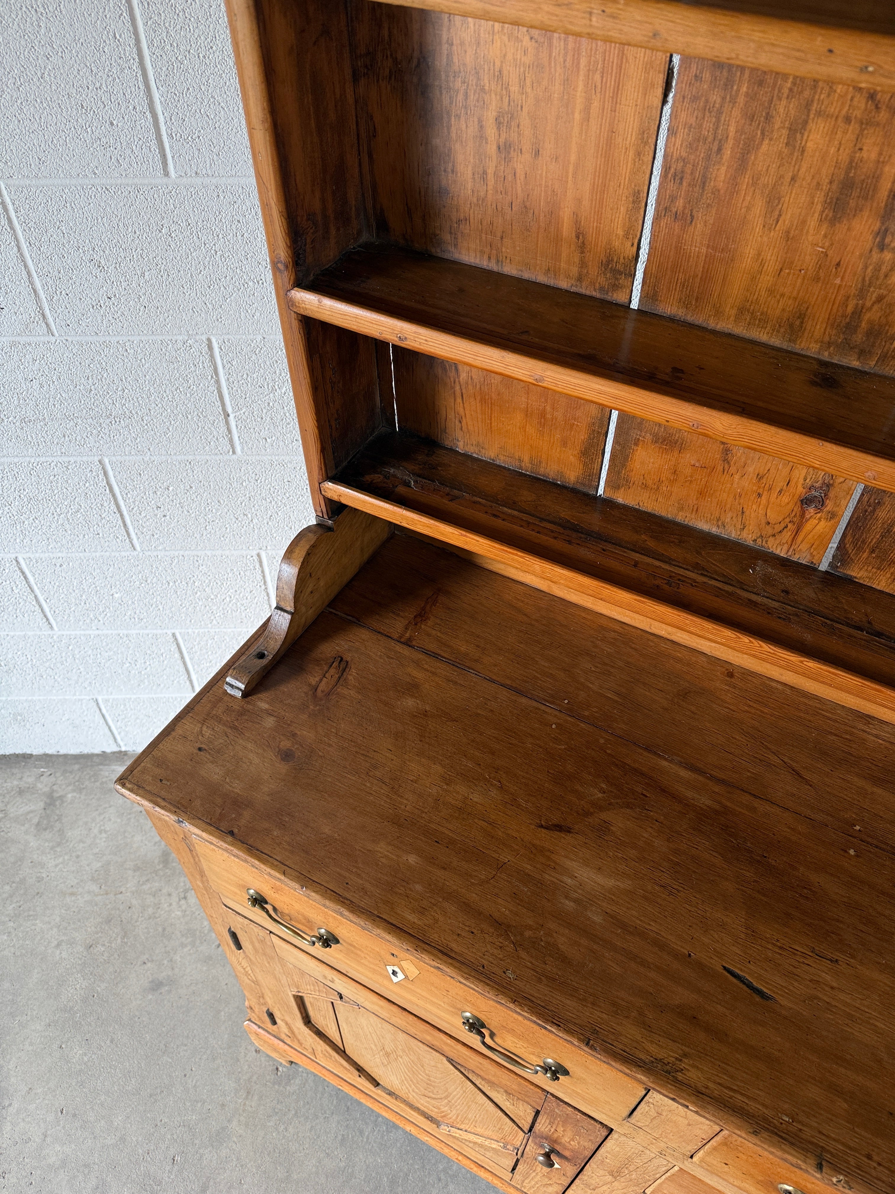 Antique English pine kitchen dresser with paneled doors and detailed trim work