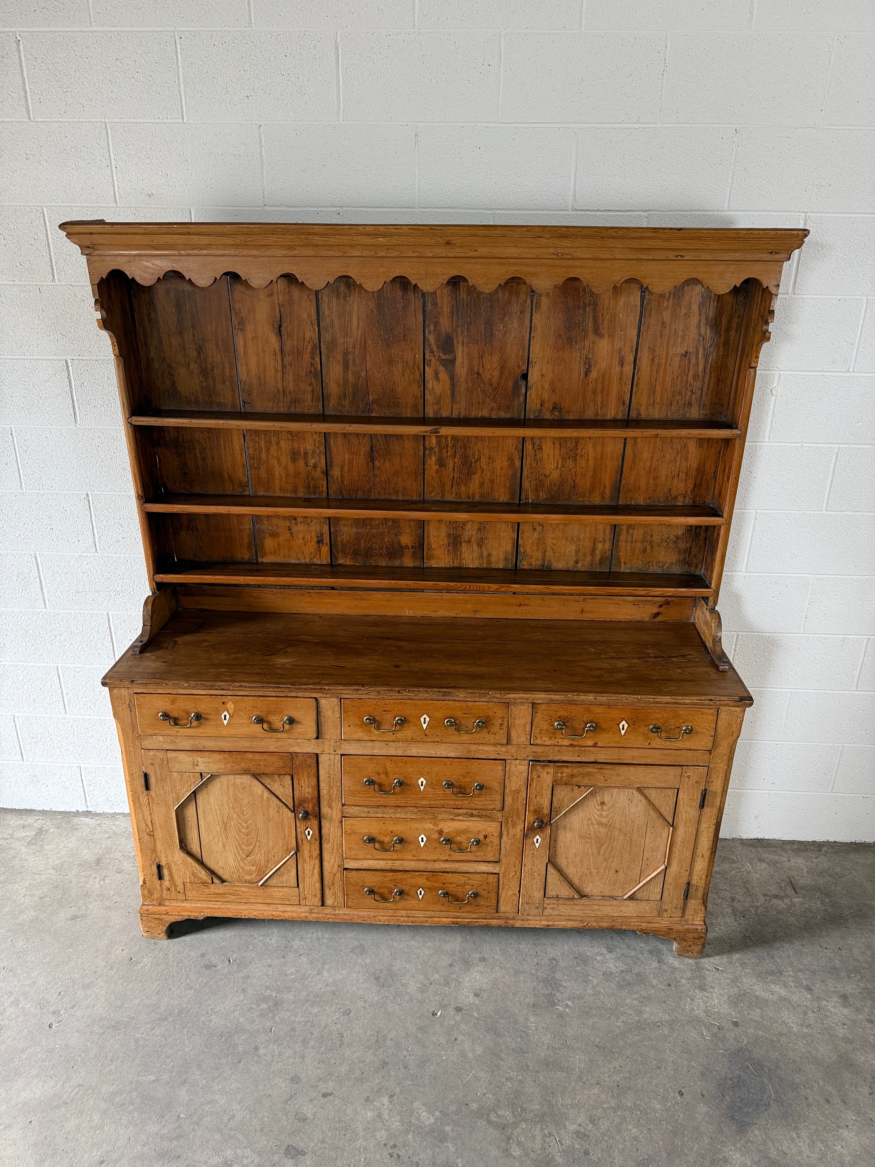 Antique English pine kitchen dresser with paneled doors and detailed trim work