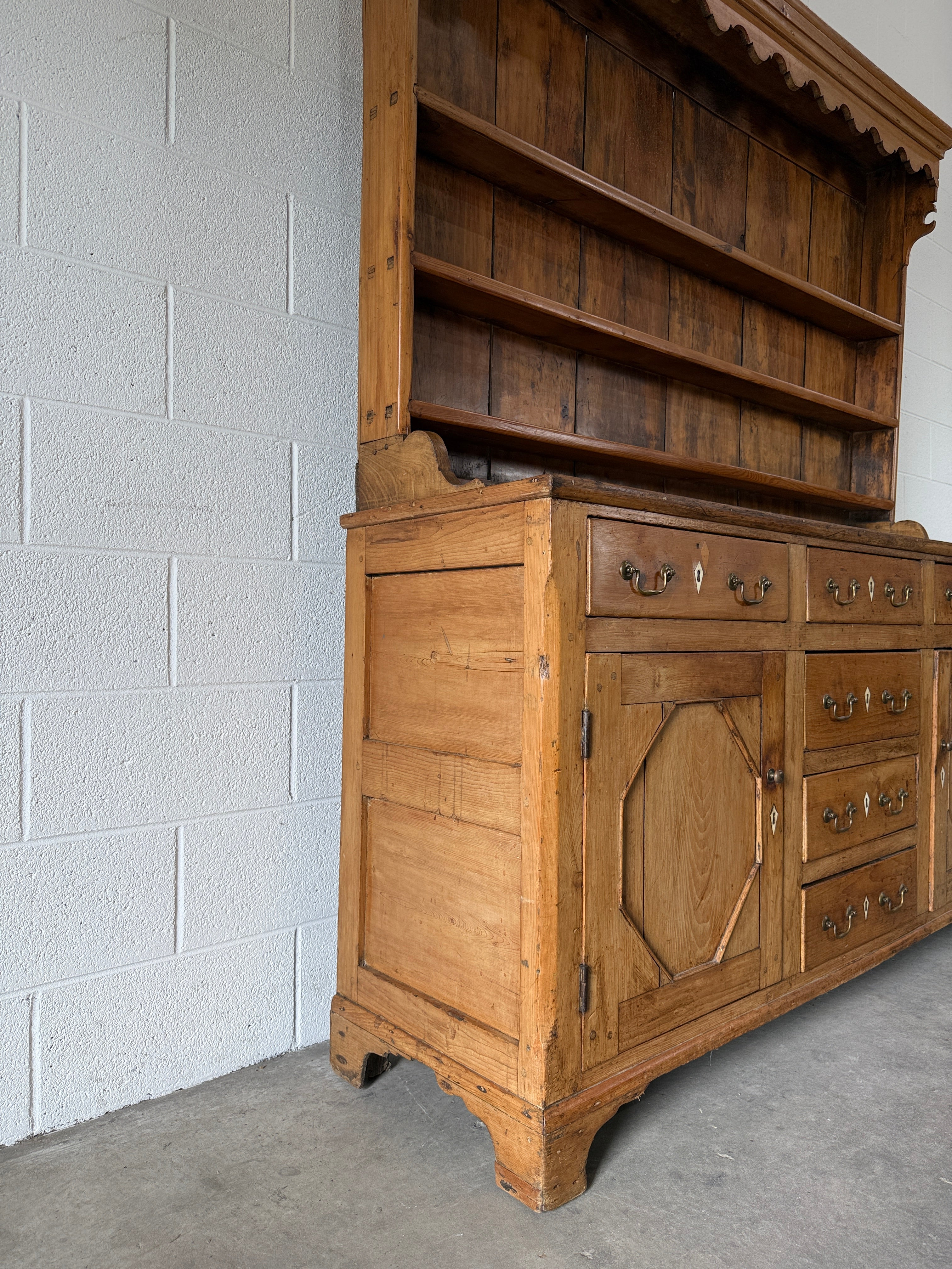 Antique English pine kitchen dresser with paneled doors and detailed trim work