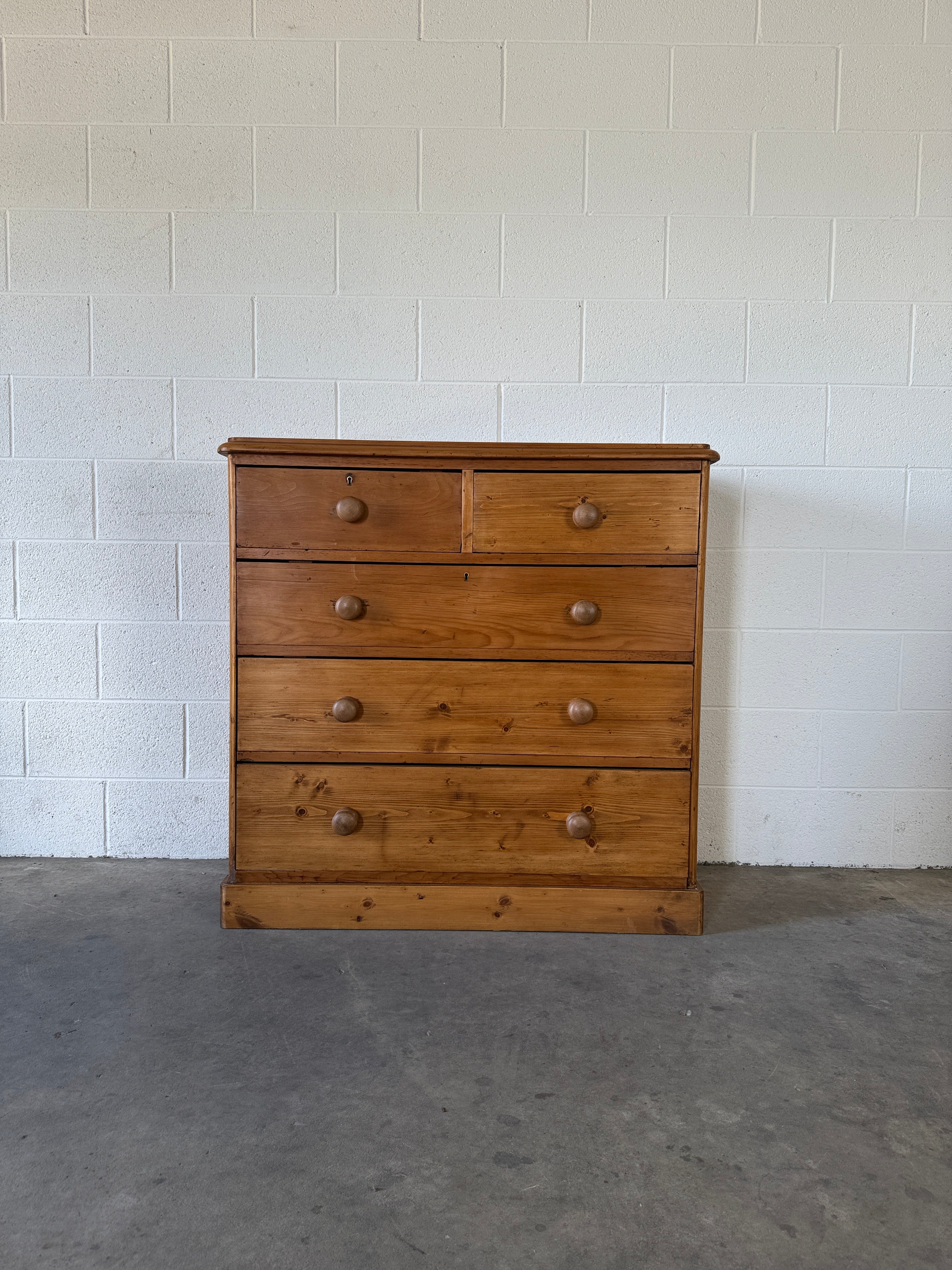 Solid antique pine chest of drawers set on plinth base