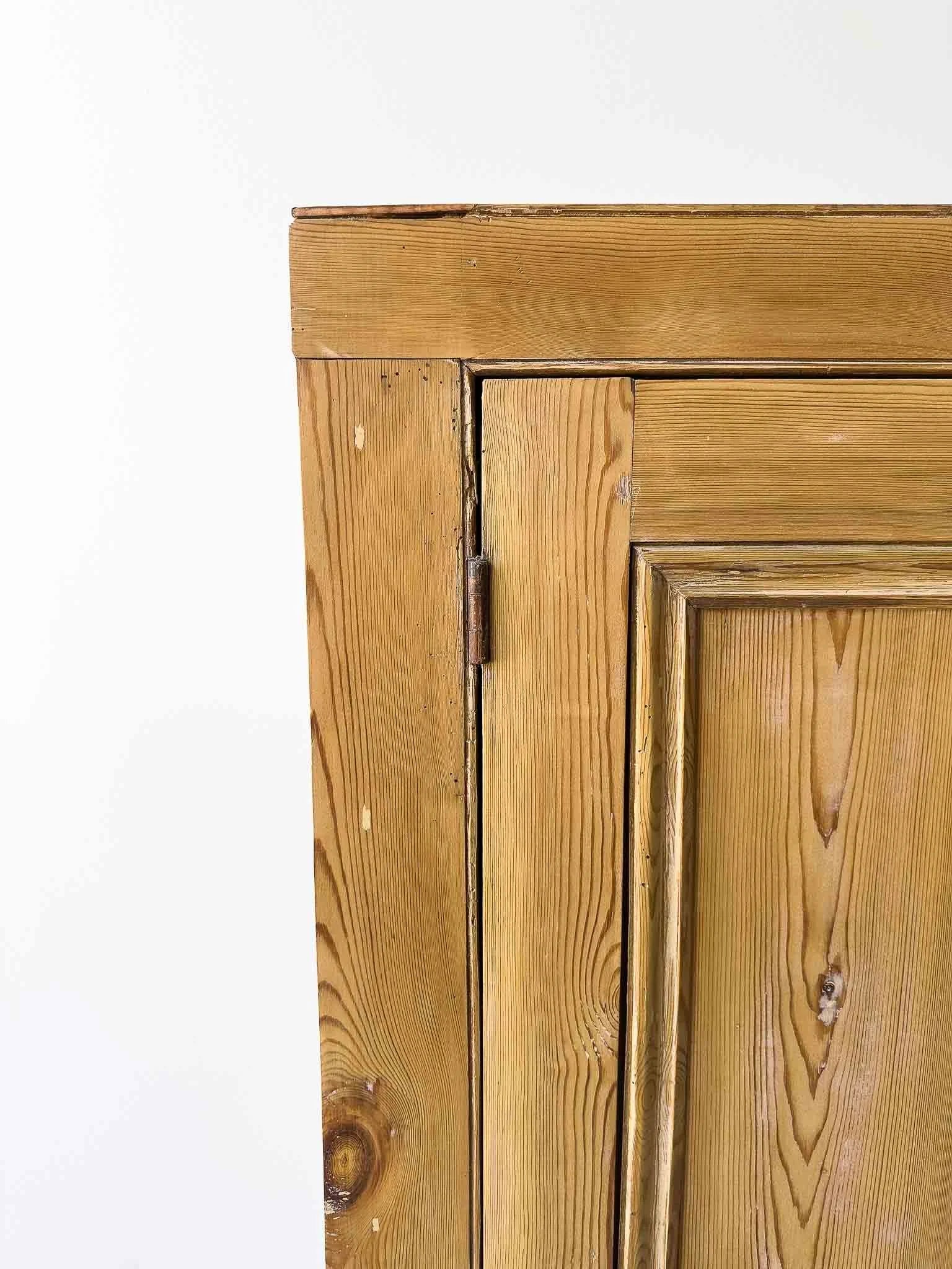 A large antique pine cupboard
