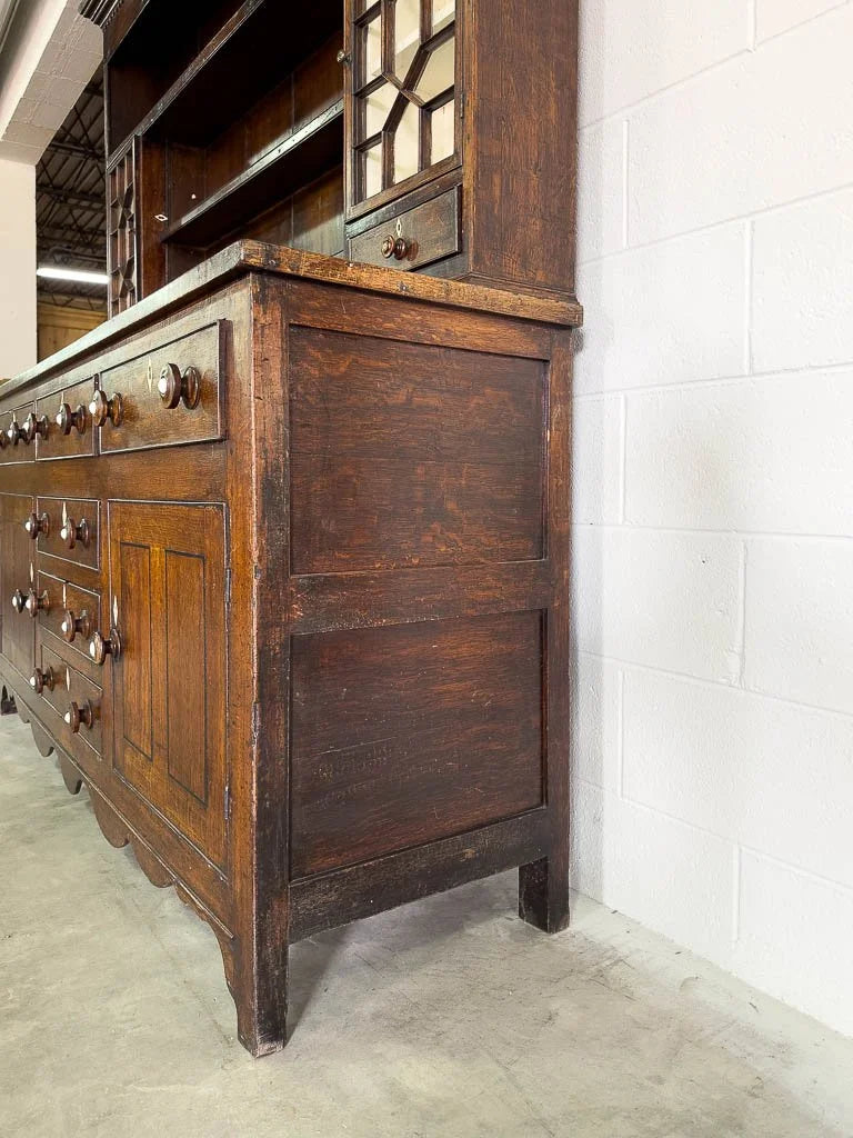 Antique English oak kitchen dresser with scalloped detail