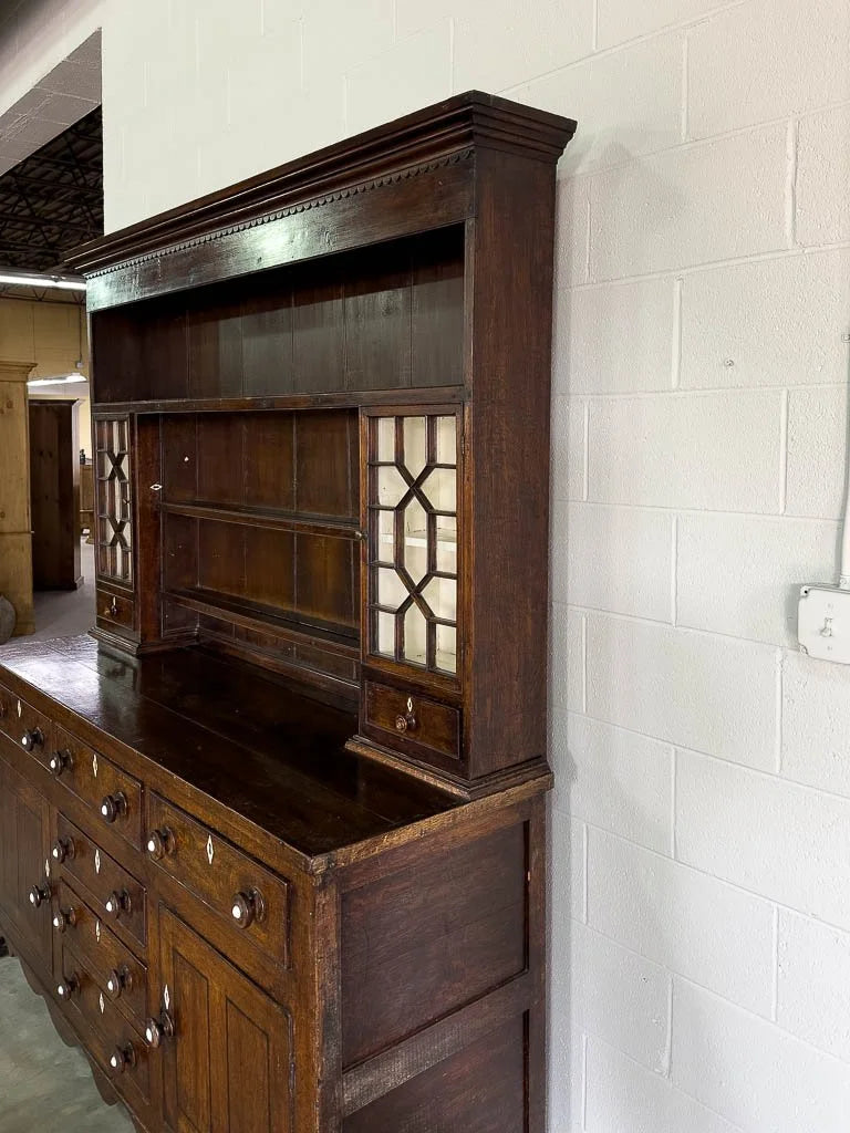 Antique English oak kitchen dresser with scalloped detail