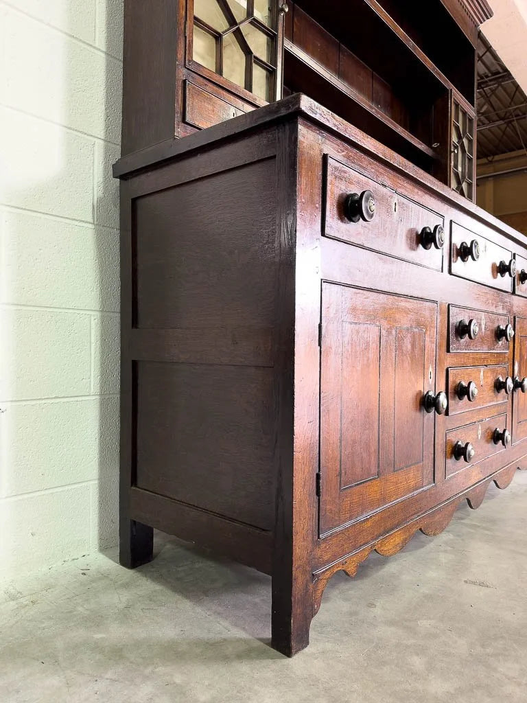 Antique English oak kitchen dresser with scalloped detail