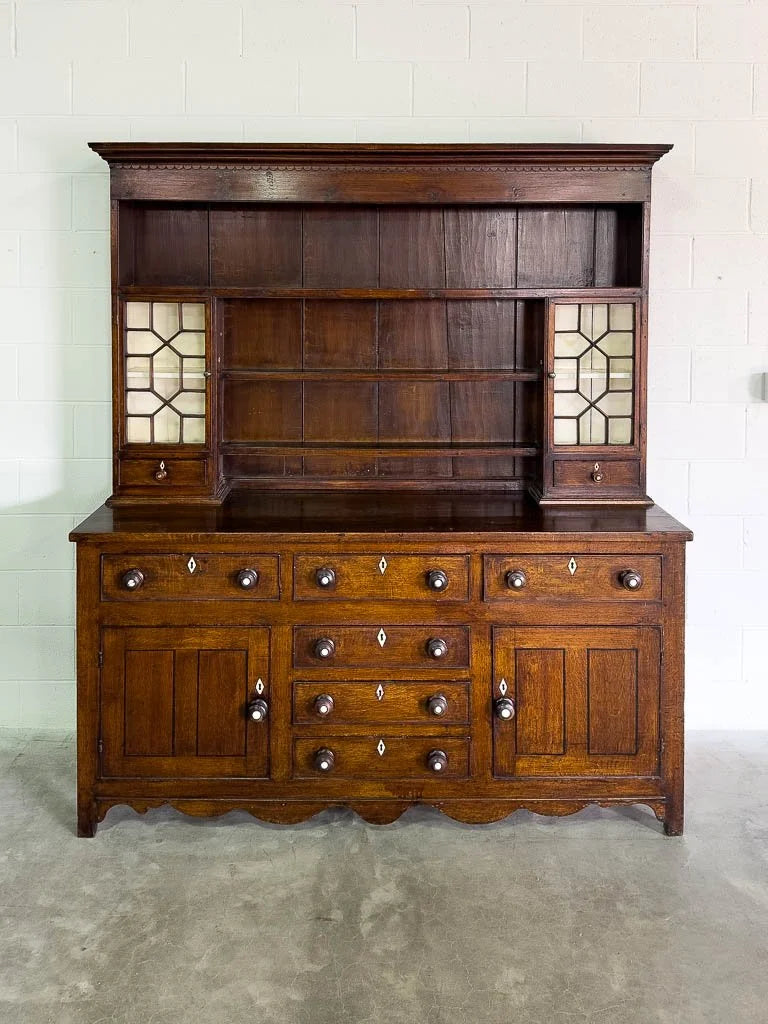 Antique English oak kitchen dresser with scalloped detail