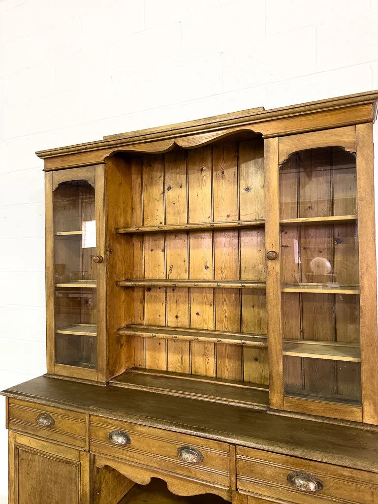 Antique European hutch with glass doors and a plate rack