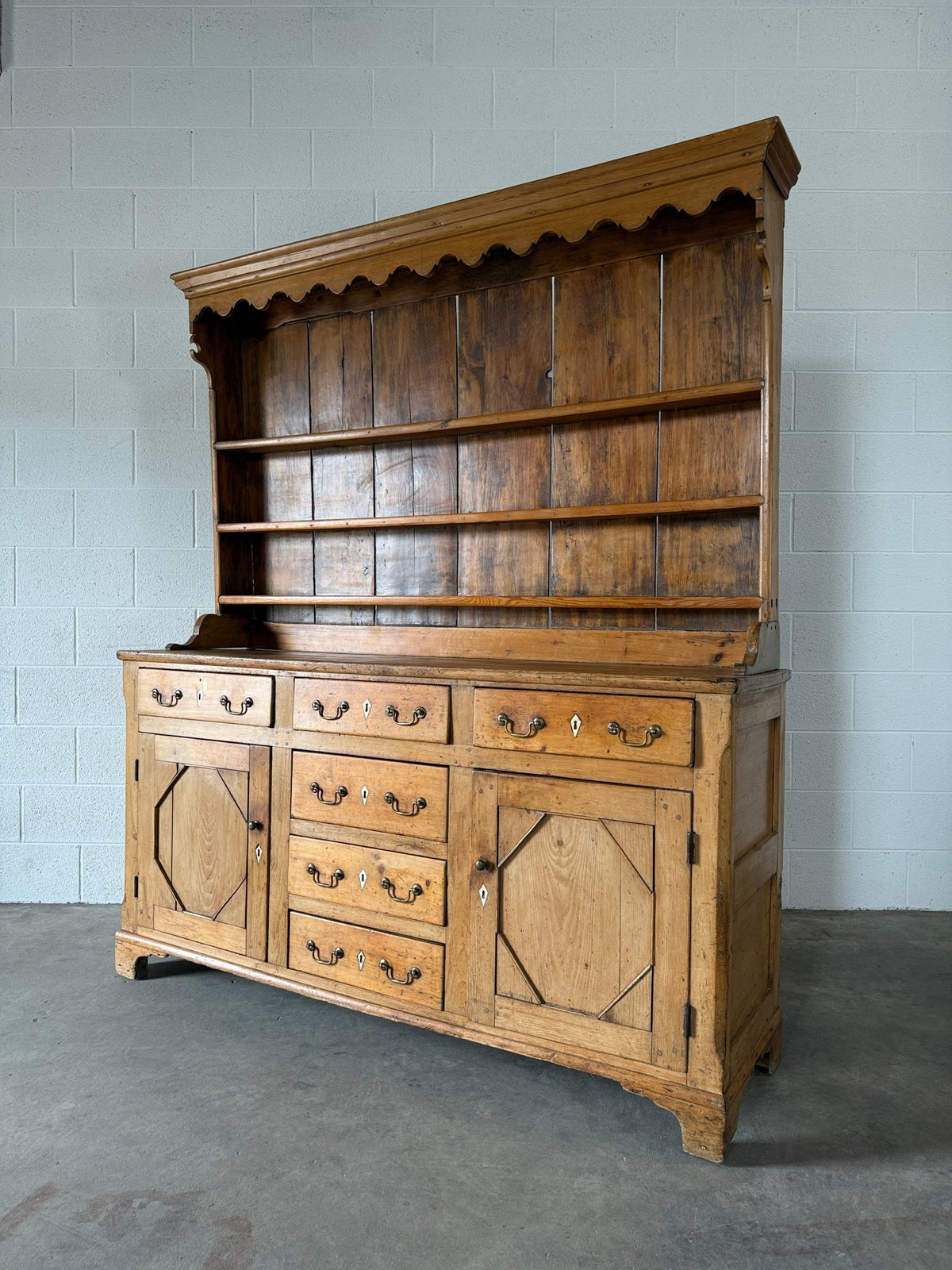 Antique English pine kitchen dresser with paneled doors and detailed trim work - House on Horizon