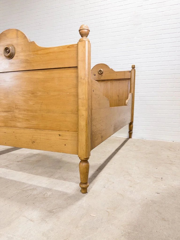 Antique English pine sleigh bed with turned rosette - House on Horizon
