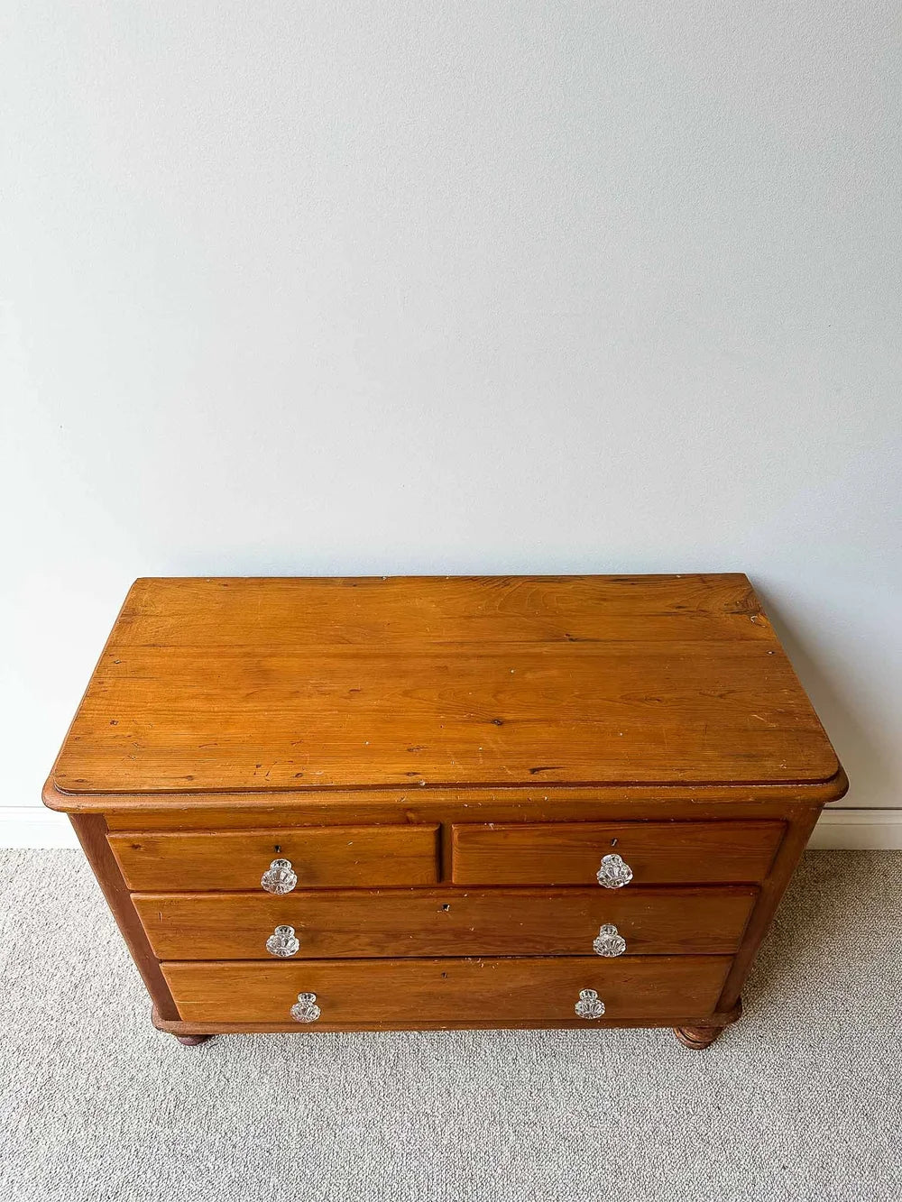 Small English pine set of drawers with glass knobs