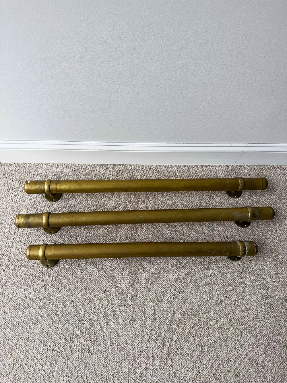 Three vintage brass foot rails