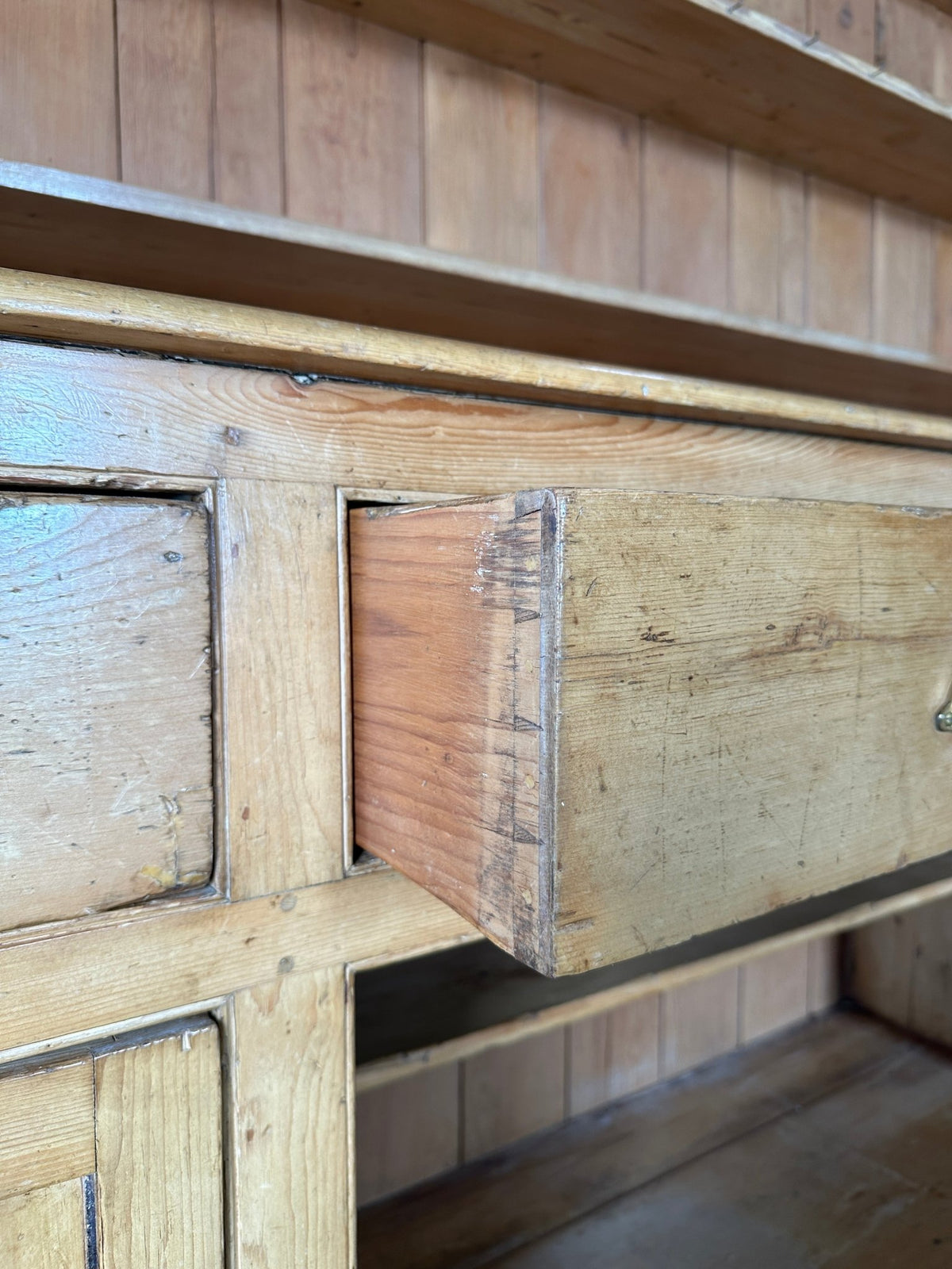 Monumental English pine kitchen dresser with brass pulls and a rounded base - House on Horizon