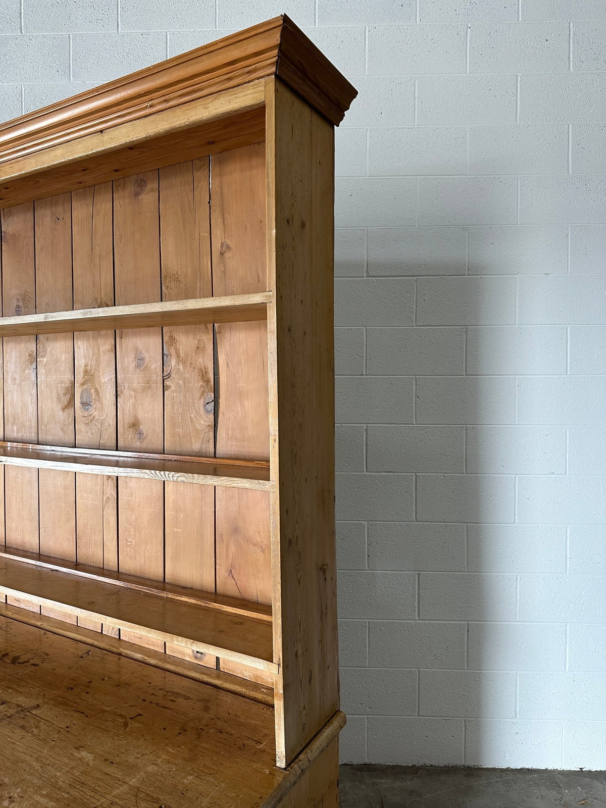 Monumental English pine kitchen dresser with brass pulls and a rounded base - House on Horizon