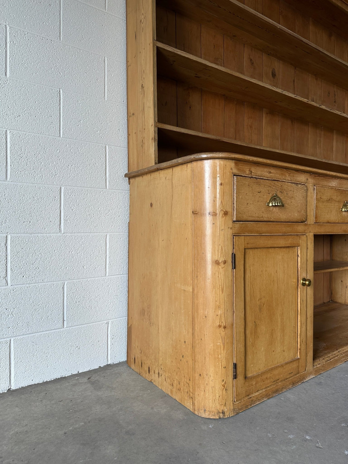 Monumental English pine kitchen dresser with brass pulls and a rounded base - House on Horizon